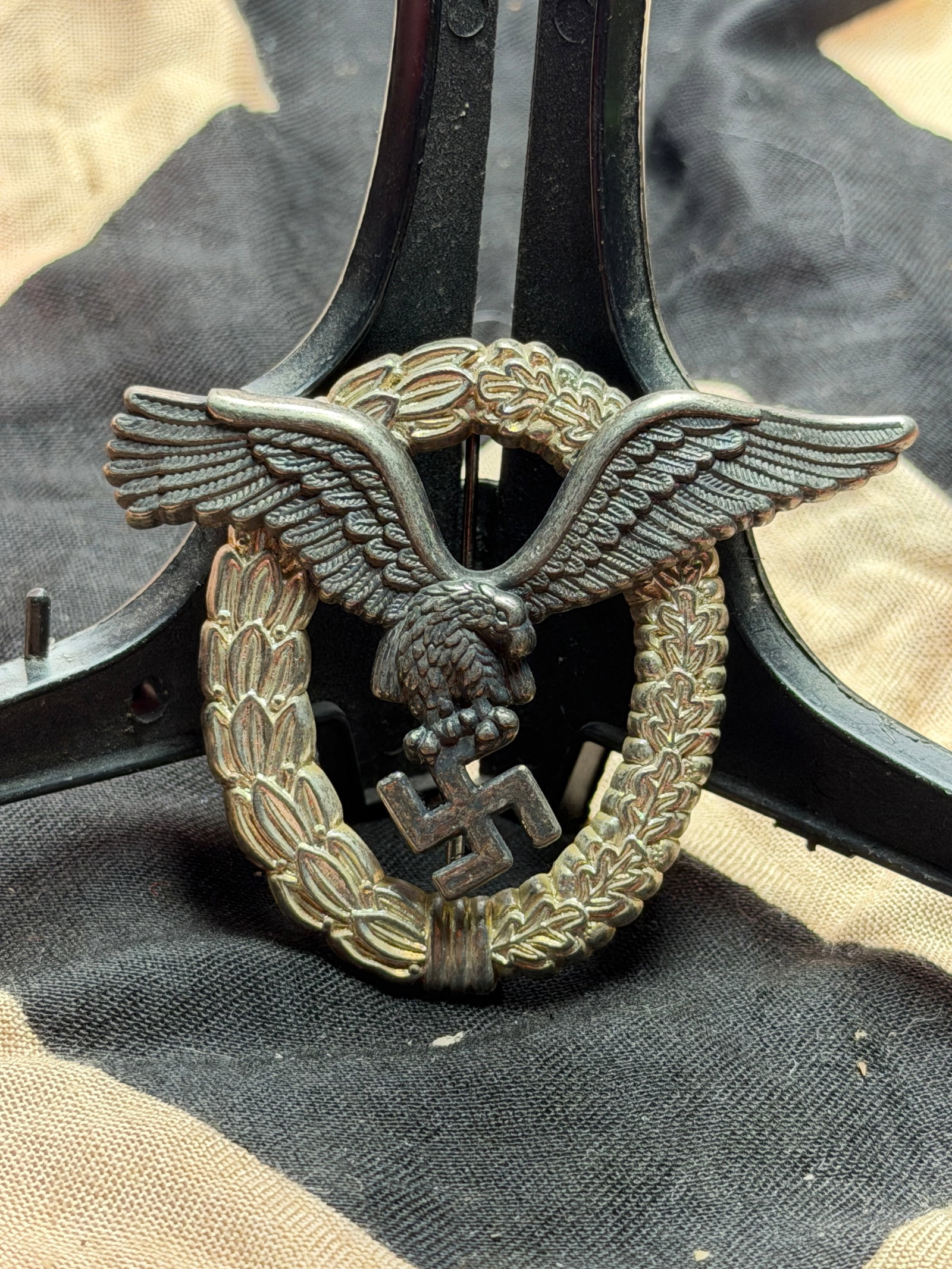 WW2 German Pilot’s Badge of the Luftwaffe (Flugzeugführerabzeichen): This metal badge is a German Luftwaffe pilot’s qualification insignia, awarded to aircrew who completed flight training during the Third Reich (1935–1945). The design features a spread-winged eagl