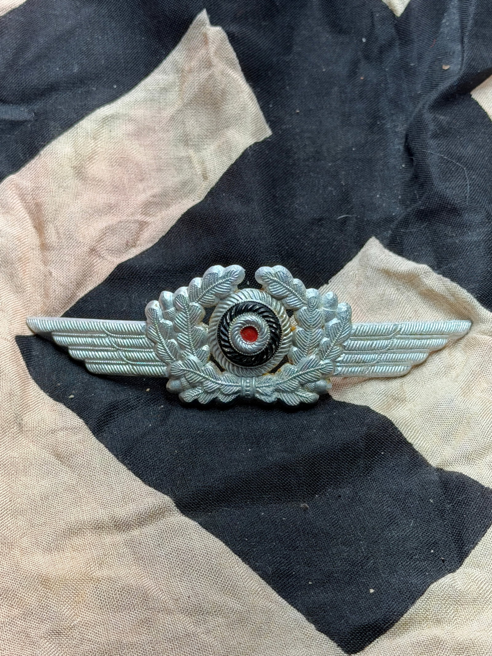 WW2 German Luftwaffe Observer’s Visor Cap Badge (Beobachterabzeichen): This metal insignia is a Luftwaffe Observer’s Badge, awarded in Nazi Germany to aircrew members—such as navigators, observers, and reconnaissance specialists—who completed the required training 