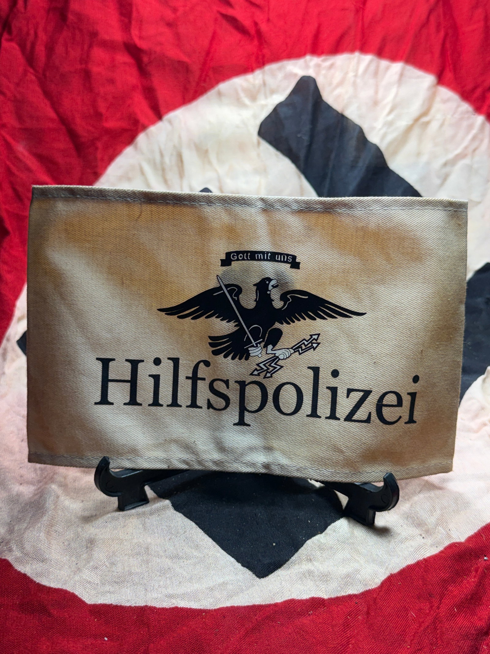 WW2 German Hilfspolizei Armband (Auxiliary Police): This armband is identified as a Hilfspolizei (Auxiliary Police) armband from Nazi Germany during the Second World War. Constructed of tan woven cloth, the armband bears the printed black inscription �