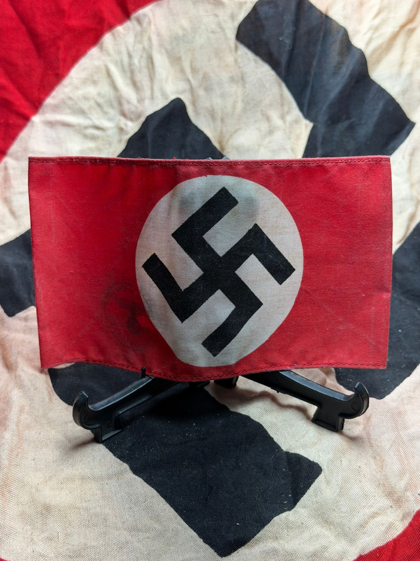 WW2 German National Socialist Armband with Stamp(NSDAP Party Insignia): This armband is a period National Socialist German Workers’ Party (NSDAP) insignia, constructed of red cotton with a centrally applied white roundel bearing a black swastika. Such armbands were amon