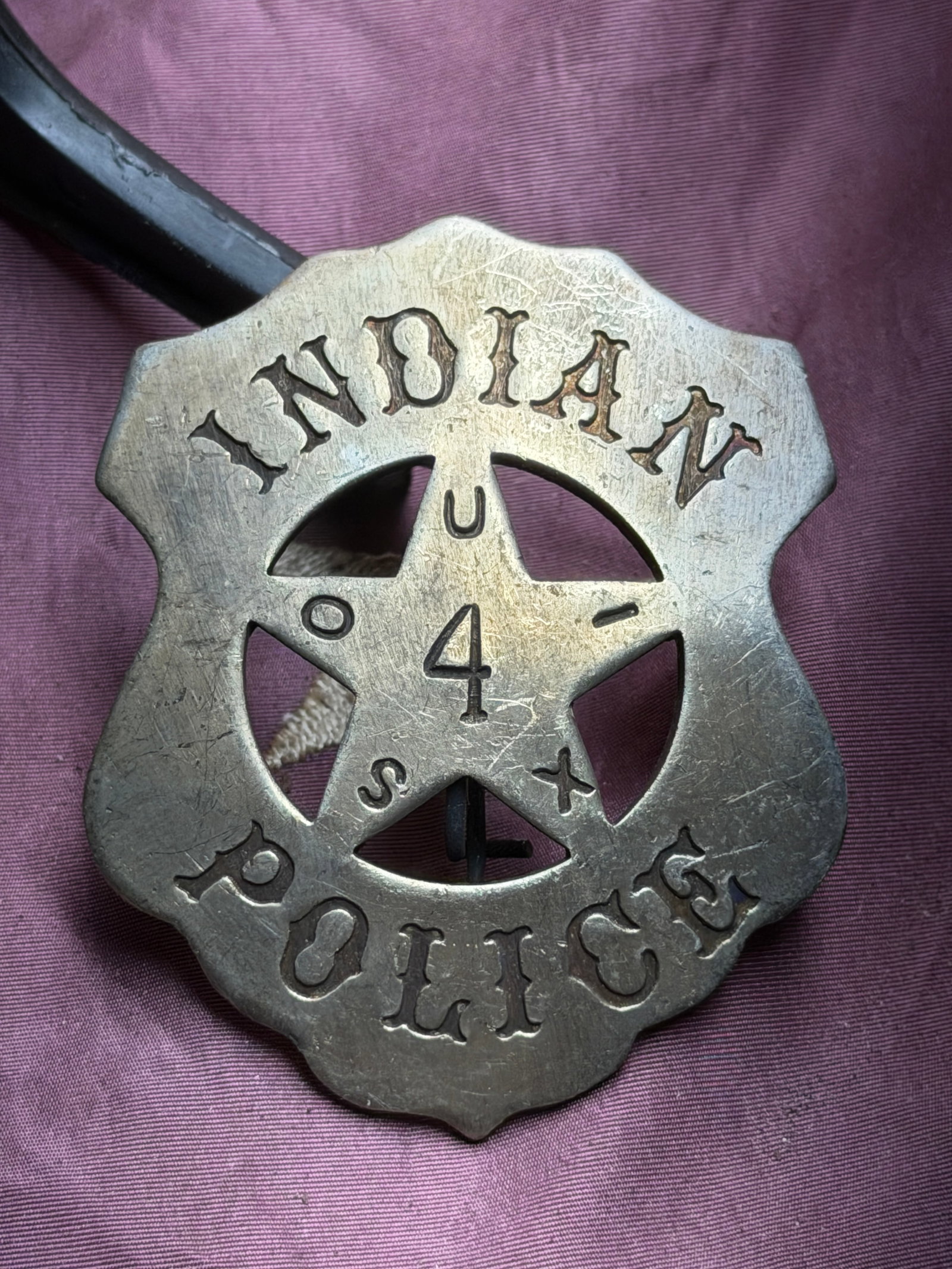Civil War Sioux Indian Police Badge, No. 4: This metal badge identified as “INDIAN POLICE” and numbered “4” is attributed to the Sioux Indian Police, a law-enforcement body operating within Sioux reservations during the late 19t