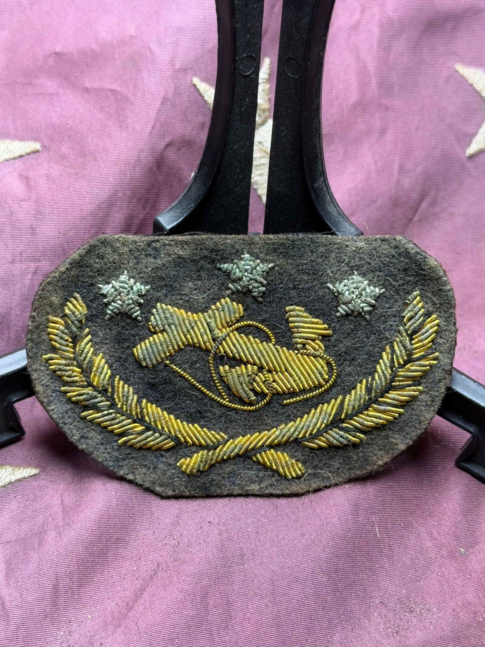 Civil War Navy Rear Admiral’s Cap Insignia (Three-Star Pattern), American Civil War Period By J.H.: This embroidered cap insignia represents the three-star rank of Rear Admiral in the United States Navy during the American Civil War era (1861–1865). Executed in gilt bullion embroidery on a dark wo