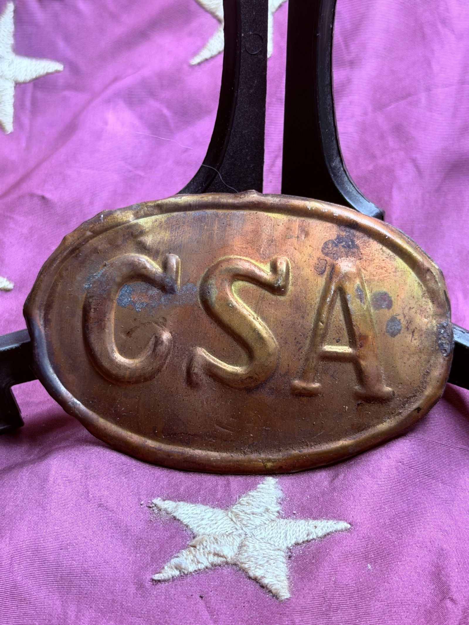 Civil War Confederate States Army (CSA) Oval Belt Plate: This oval brass belt plate bears the raised letters “C.S.A.”, signifying the Confederate States Army during the American Civil War (1861–1865). Such plates were worn on the waist belts of Co