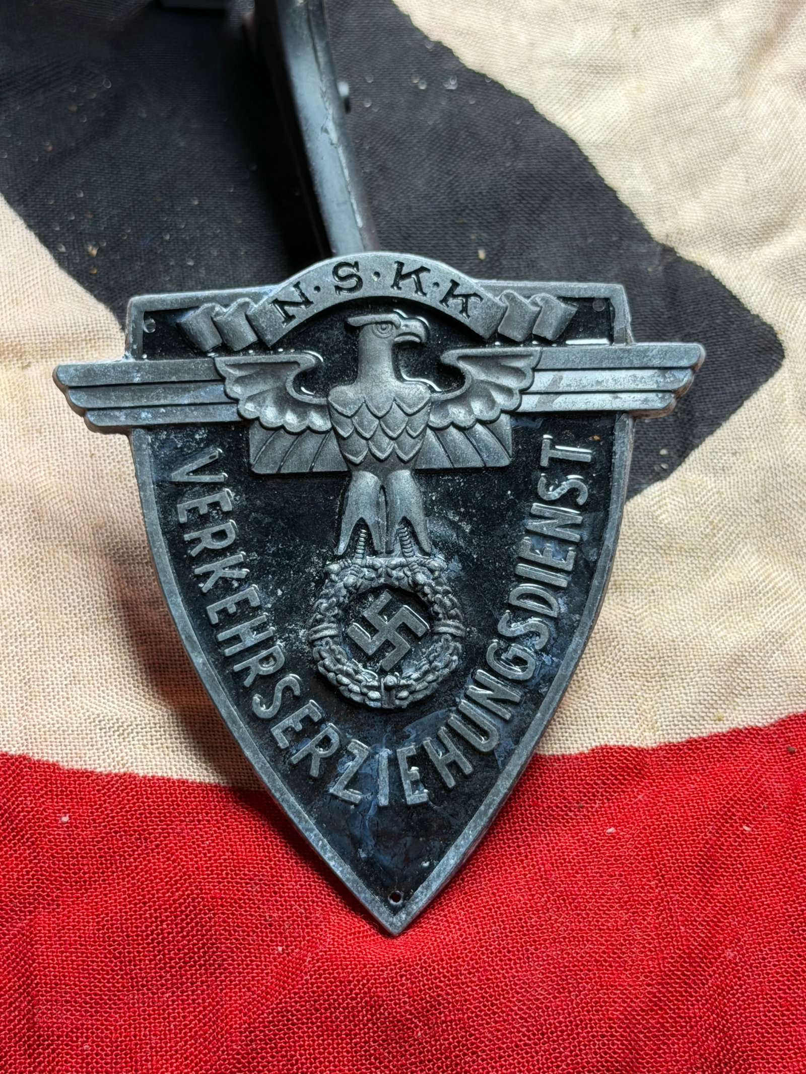 WW2 Shield of Surveillance: Insignia of the German Verkehrserziehungsdienst (Traffic Education: This metal shield-shaped badge represents the Verkehrserziehungsdienst (Traffic Education Service), a specialized auxiliary organization operating in Germany during the Third Reich (1930s–1945). Bea