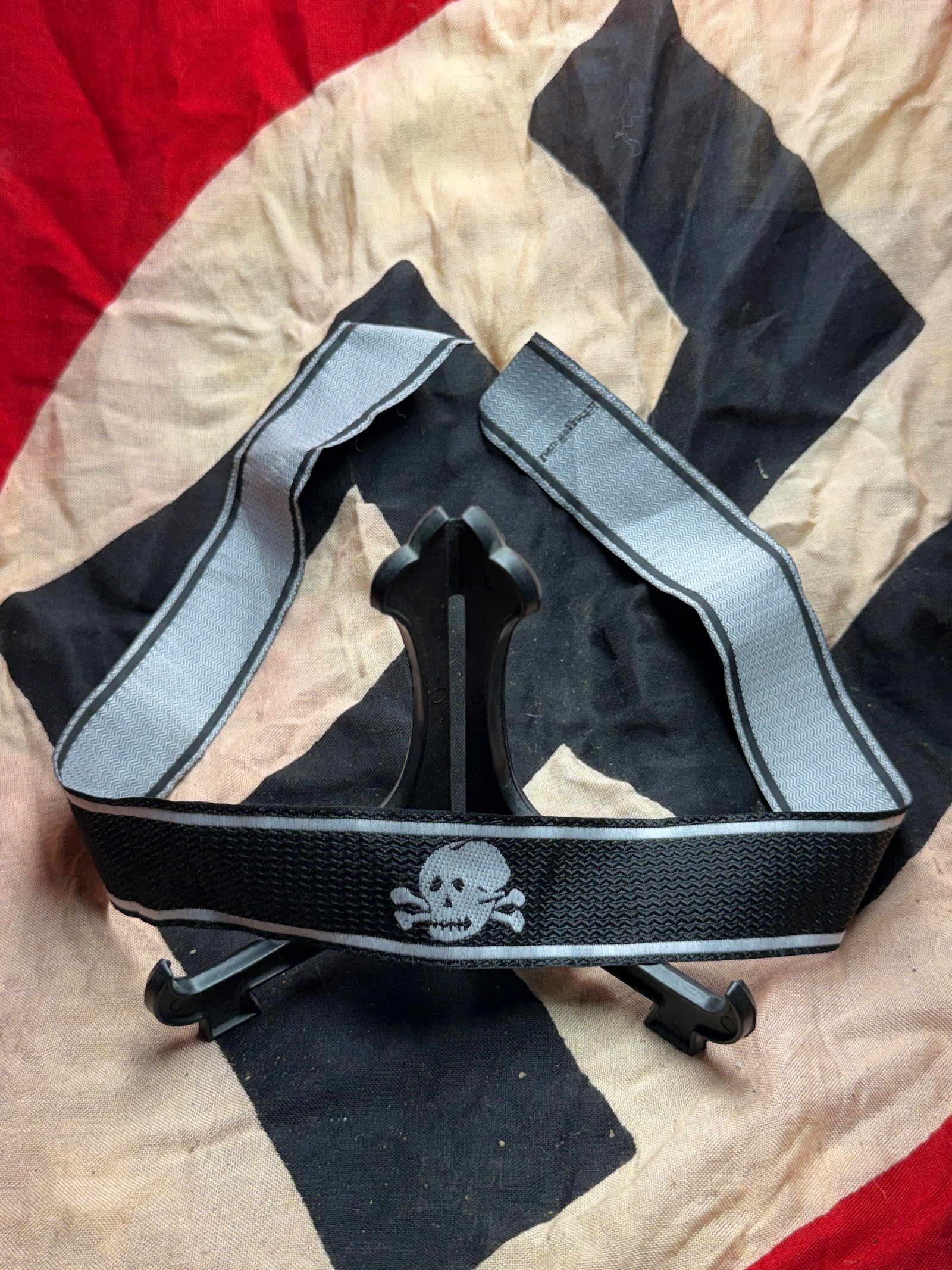WW2 German Totenkopf-Emblazoned Armband: This armband features the Totenkopf (skull and crossbones) emblem, a symbol historically employed by certain German military and paramilitary formations during the Third Reich. Constructed from woven 
