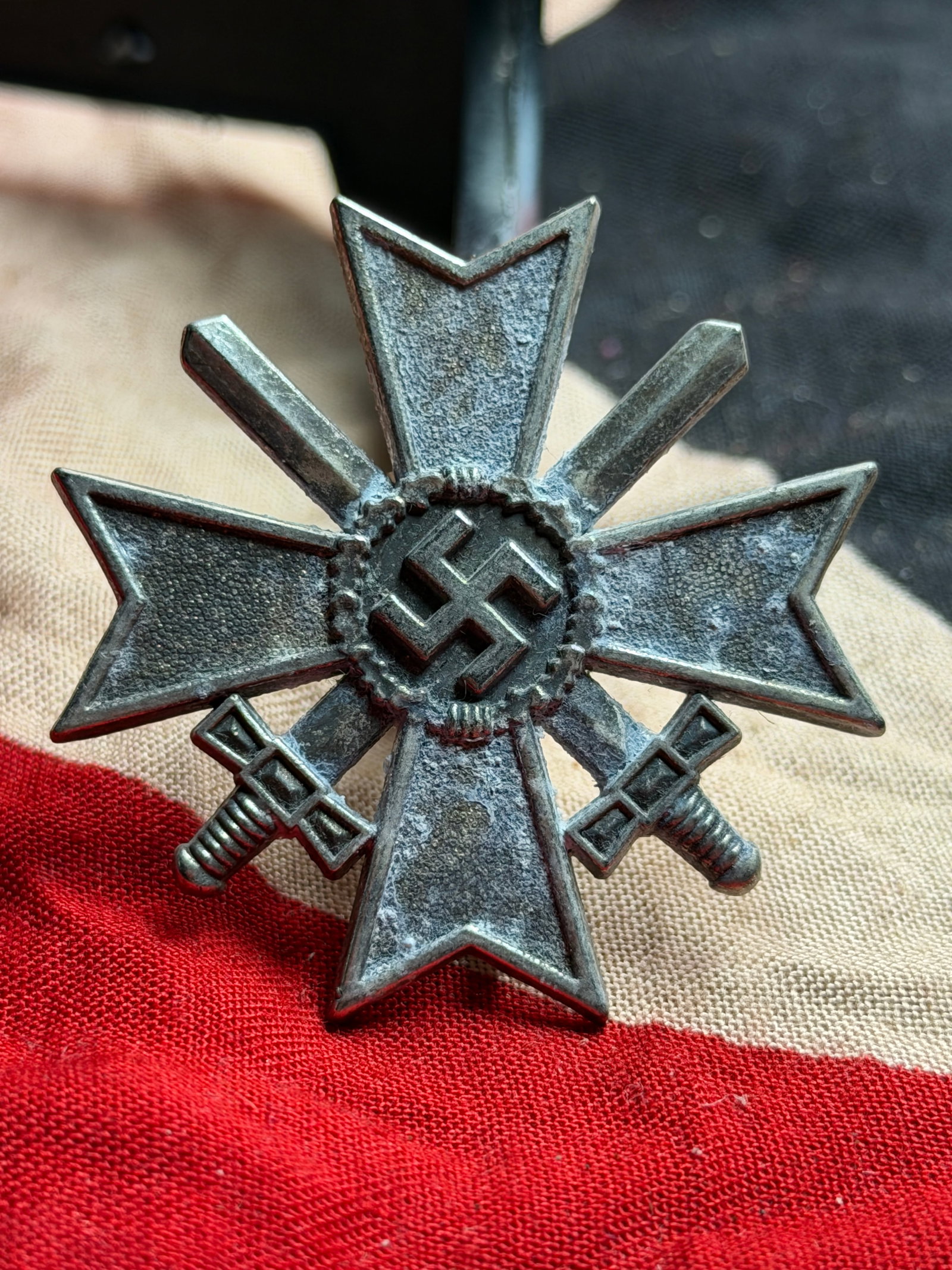 WW2 German War Merit Cross with Swords (Kriegsverdienstkreuz mit Schwertern): This medal is a German War Merit Cross with Swords, instituted in 1939 to recognize acts of bravery or merit in support of the war effort that did not meet the criteria for the Iron Cross. The design 