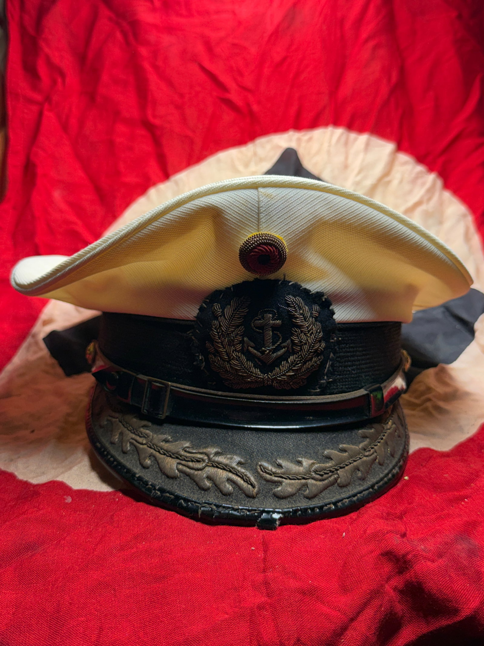 WW2 German Kriegsmarine Officer’s Visor Cap (Peaked Cap), c. 1935–1945: This German naval officer’s visor cap represents the formal headgear worn by commissioned officers of the Kriegsmarine, the navy of Germany during the Second World War. The cap features a white summ