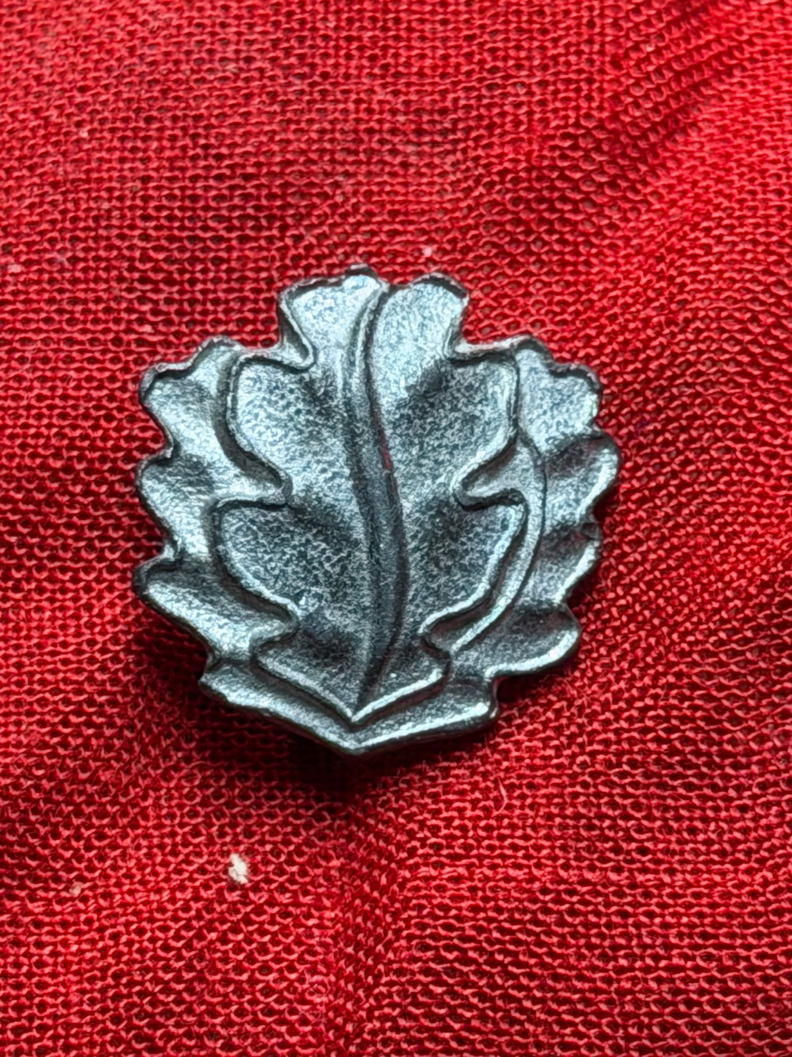 WW2 German Oak Leaves Device for the Knight’s Cross of the Iron Cross (Eichenlaub): This metal insignia represents the Oak Leaves (Eichenlaub) awarded in conjunction with the Knight’s Cross of the Iron Cross, one of the highest military decorations of the Third Reich during the Sec