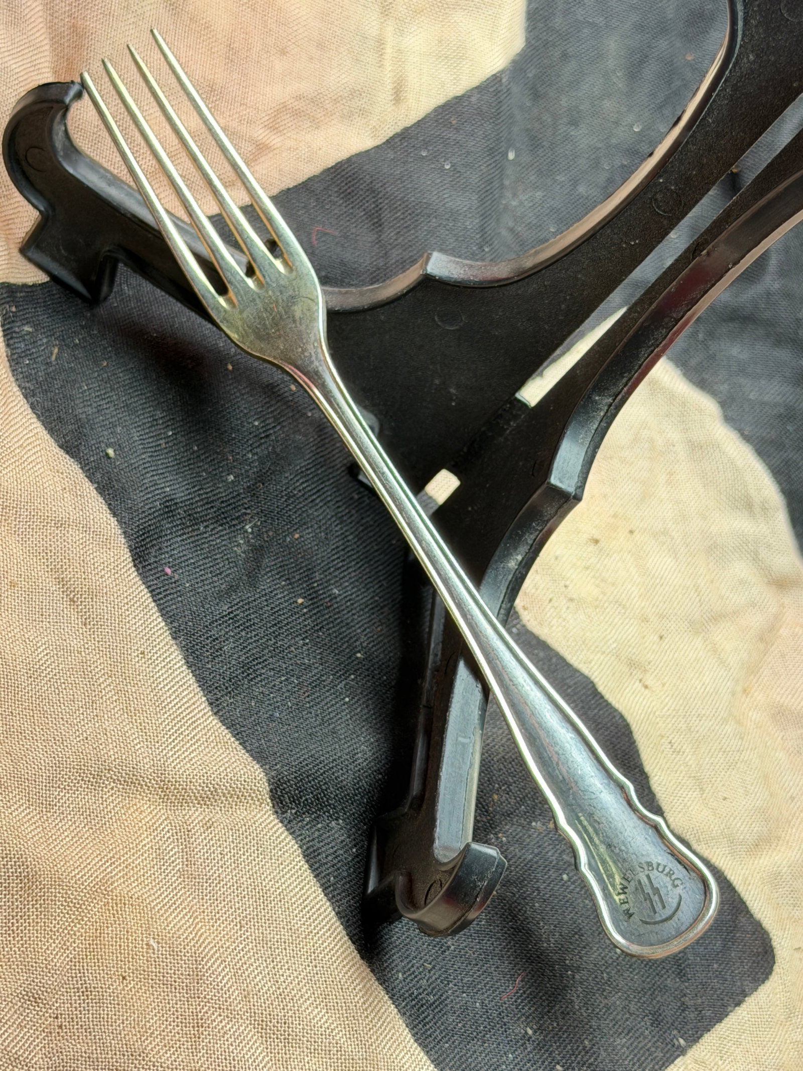 WW2 German SS Table Fork with Wolfsburg Rune Mark: This metal table fork is an example of utilitarian dining ware produced for the Schutzstaffel (SS) during the period of National Socialist Germany (1933–1945). The handle bears the Wolfsburg rune em