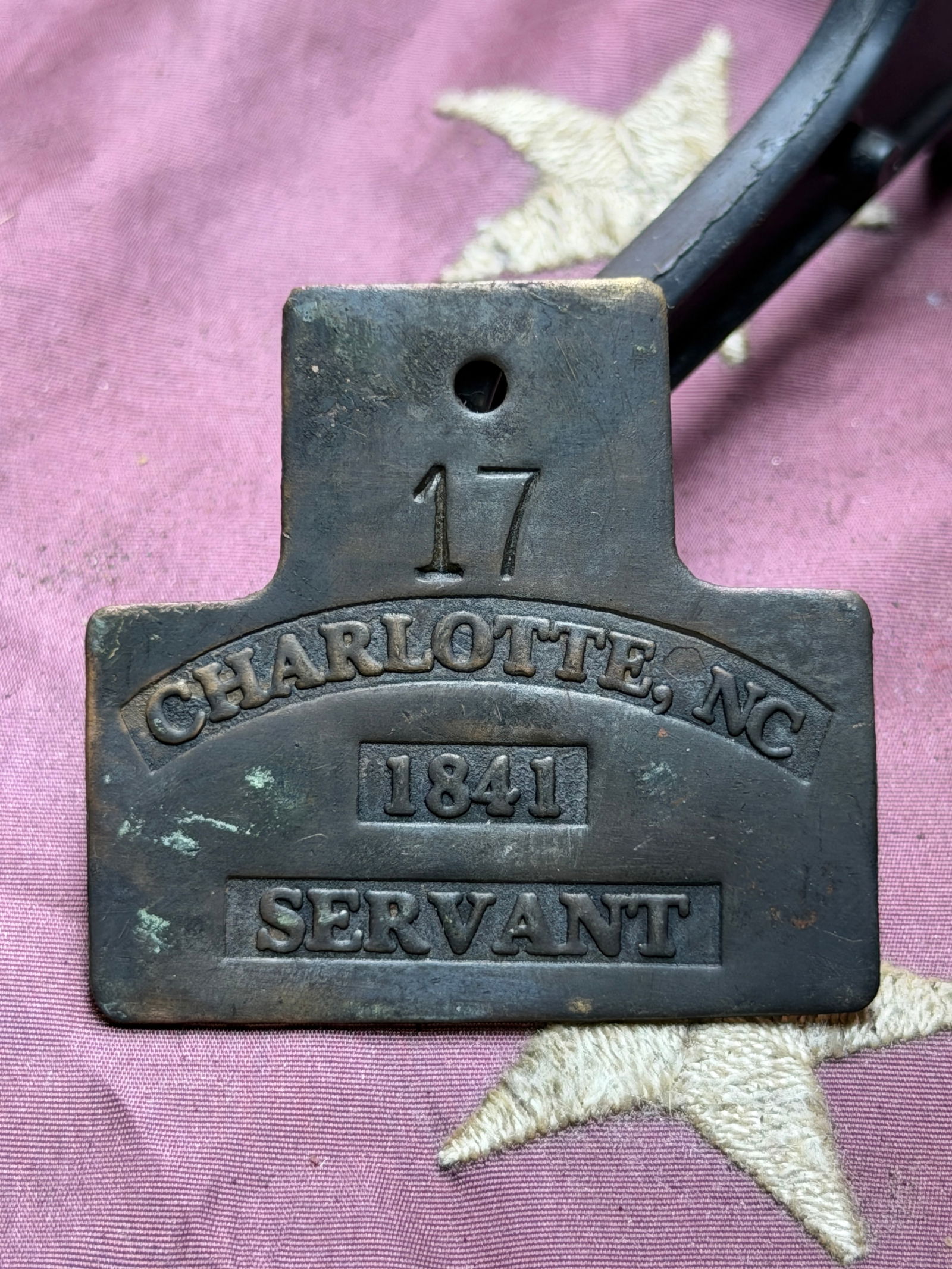 1841 Charlotte, North Carolina Servant Badge Slave Tag No. 17: This is an original mid-19th century American occupational badge issued in Charlotte, North Carolina, dated 1841 and marked “Servant” with the identifying number 17. Made of cast brass or bron