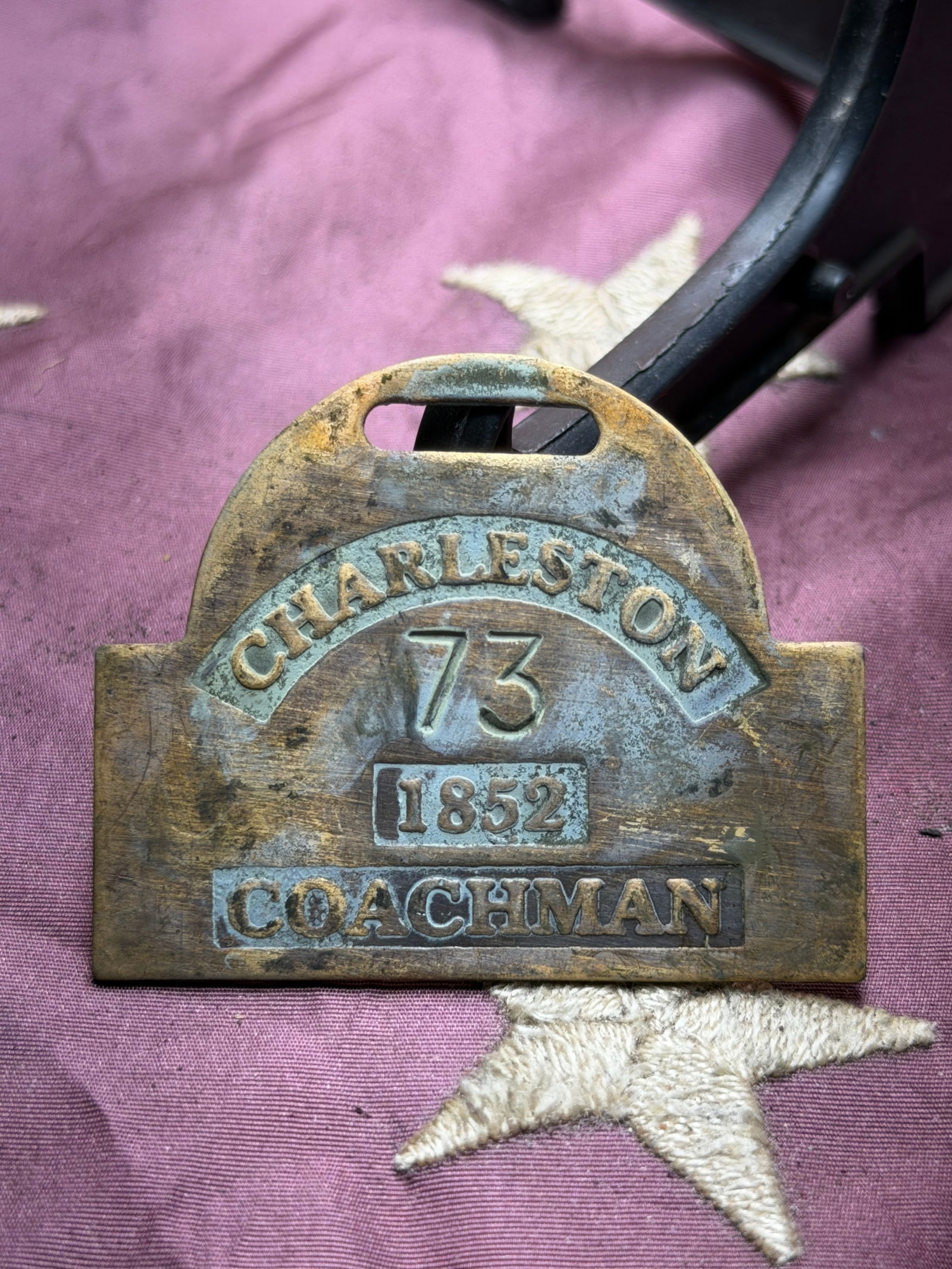 1852 Charleston Coachman Badge No. 73 – Antique Brass Slave Tag Servant Identification Tag: Mid-19th century brass servant identification badge issued in Charleston, dated 1852, and numbered 73, designating the role of Coachman. This authentic period badge features raised lettering and numer