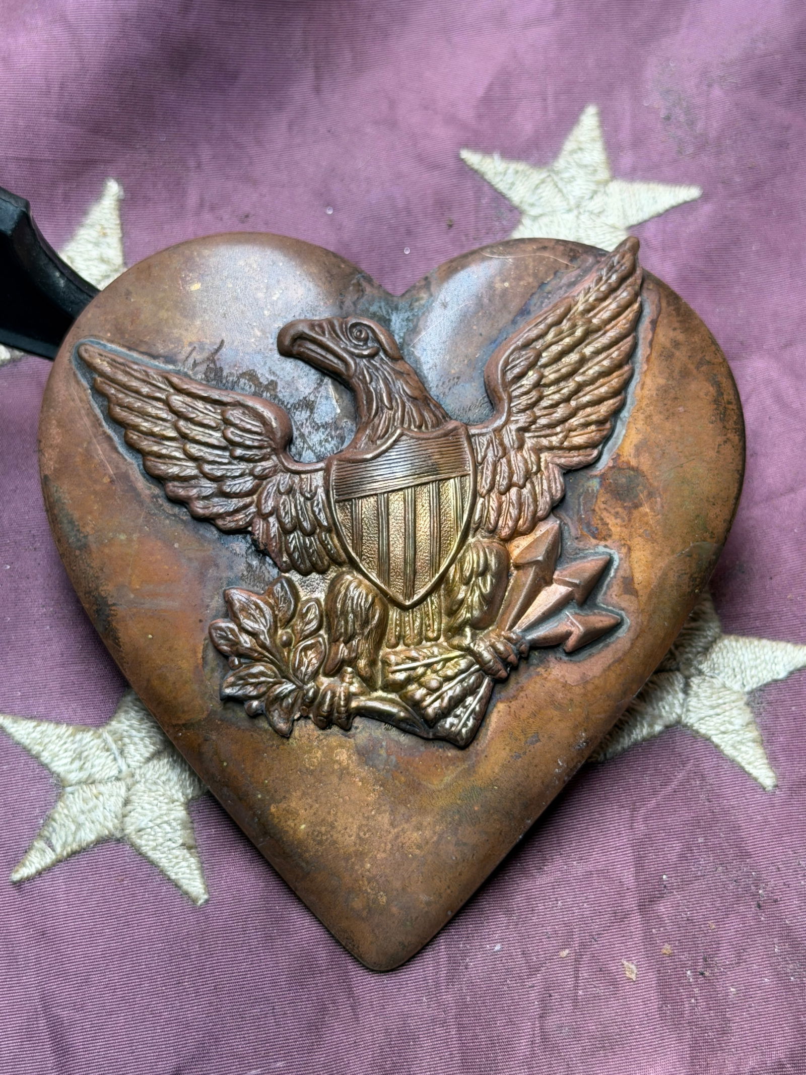Union Eagle Heart Martingale Plate (Civil War Era): This heart-shaped brass martingale plate dates to the American Civil War (1861–1865) and features a prominently raised Federal eagle with outstretched wings, shielded breast, and arrows of war, embl