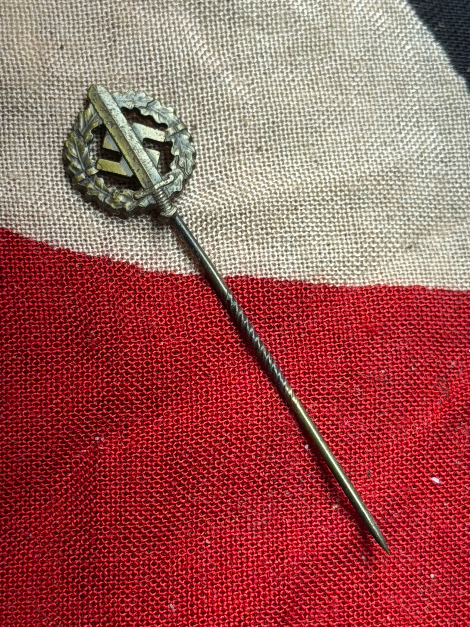 WW2 German SA Sports Badge (SA-Sportabzeichen), Miniature Stickpin: This miniature stickpin represents a reduced-size version of the SA Sports Badge (SA-Sportabzeichen), a physical fitness award instituted in 1933 by the Sturmabteilung (SA). The full-size badge was aw