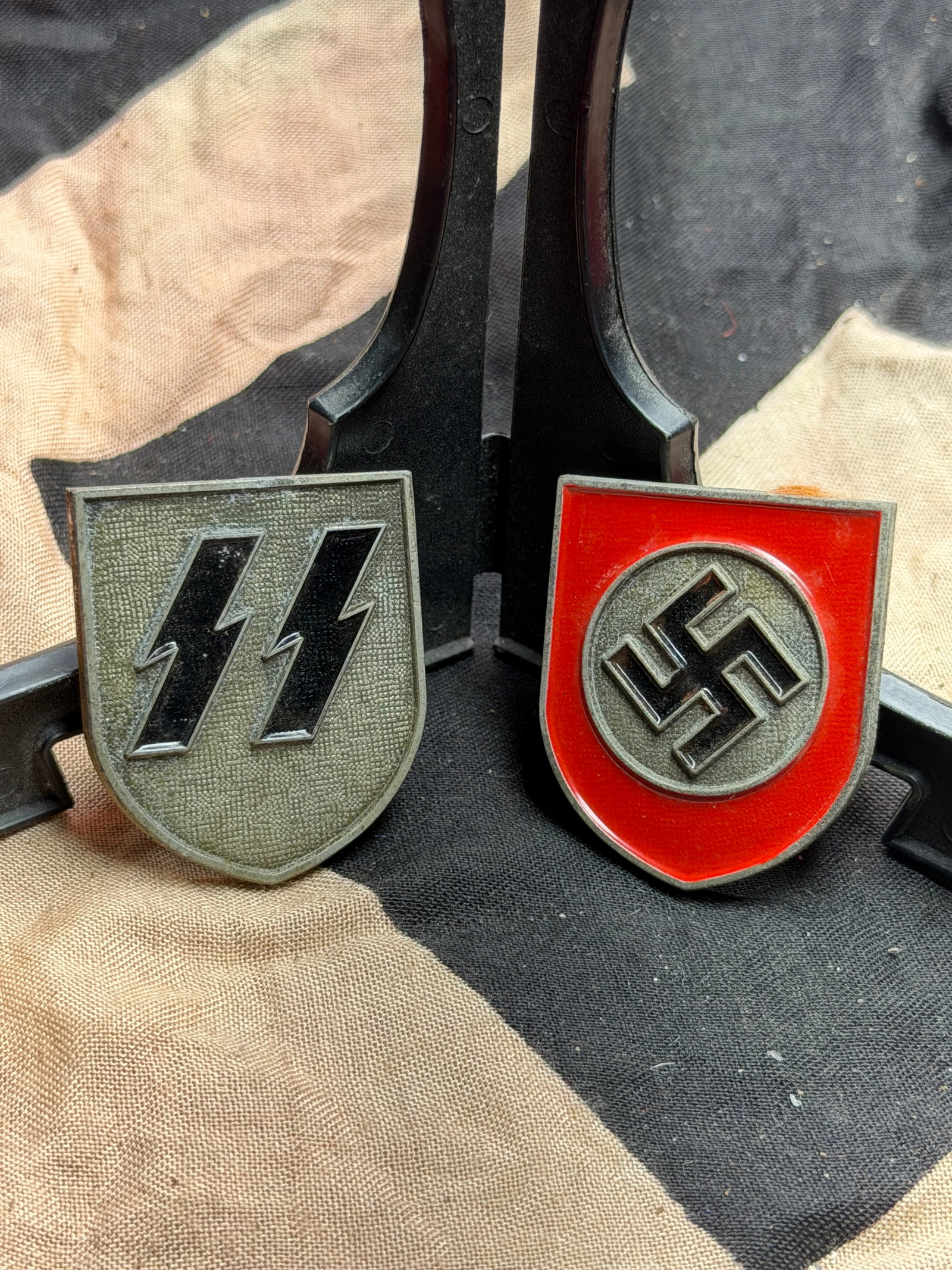 WW2 German Waffen-SS and National Socialist Party Shield Insignia (Pair): WW2 German Waffen-SS and National Socialist Party Shield Insignia (Pair). A rare find. Maker marked on the reverse. Please view all detailed pictures. A rare example of the time period. Note: In-house
