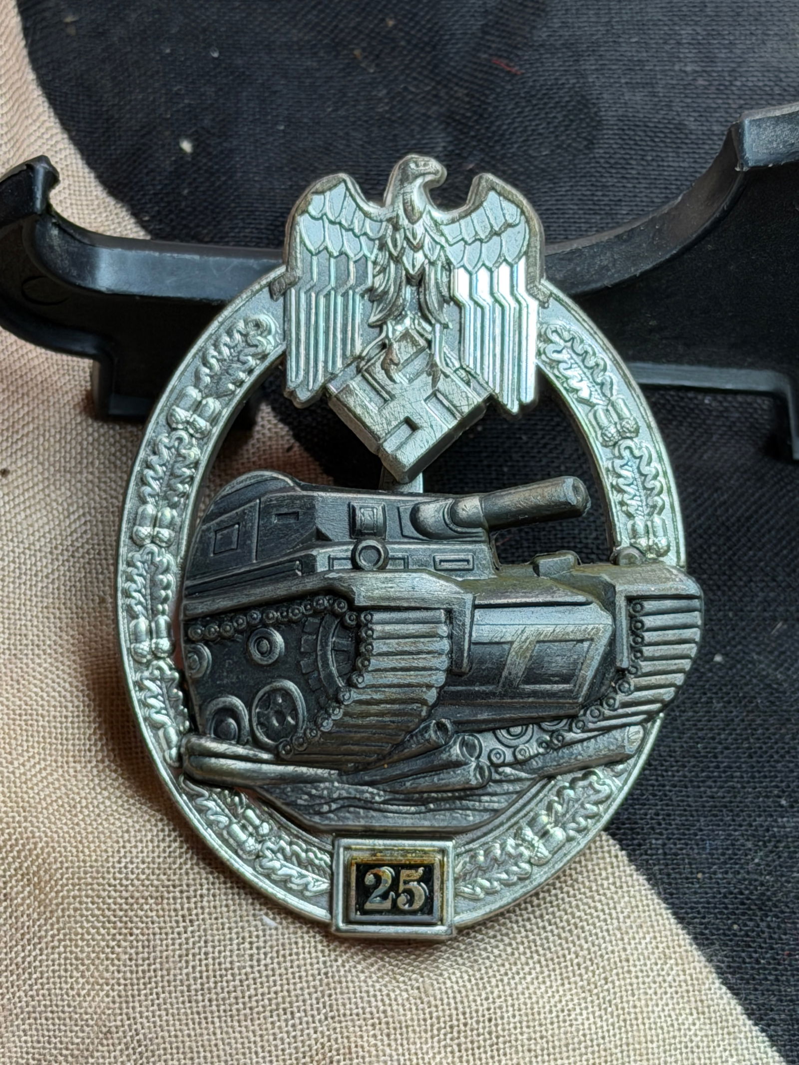 WW2 German Panzer Assault Badge in Silver with “25?? Award Plate By JFS: This badge is a Panzer Assault Badge in Silver, a combat award instituted by the German Army (Heer) to recognize armored troops for direct participation in tank assaults. Maker Marked JFS on the rever