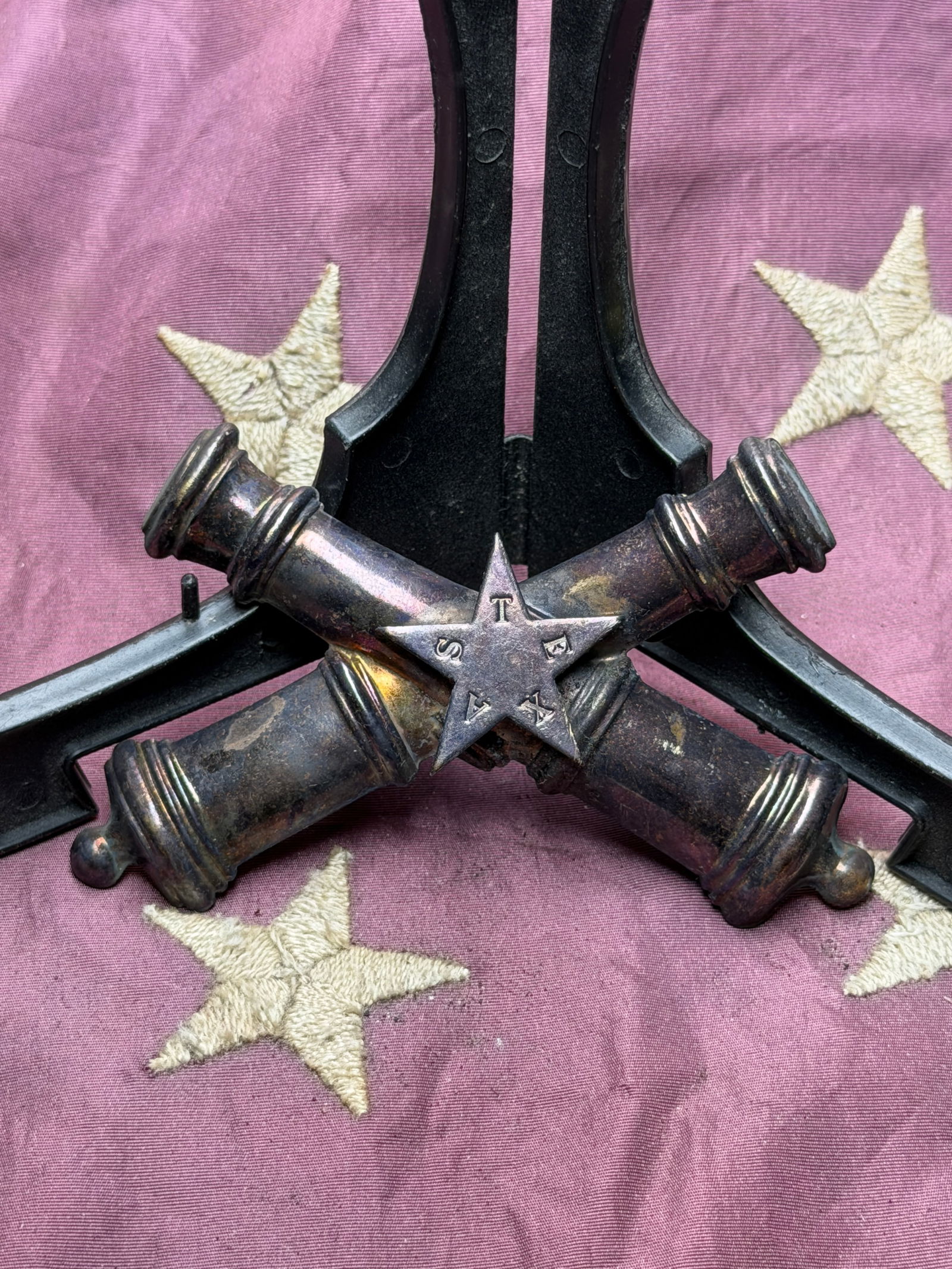 Civil War Confederate Texas Artillery Insignia with Lone Star: This crossed-cannon insignia bearing a central five-pointed Lone Star represents Texas artillery units serving the Confederacy during the American Civil War. The crossed cannons identify the artillery