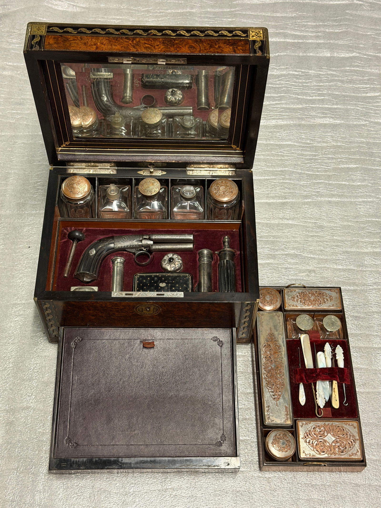 1868 Cased Traveling Pistol and Gentleman’s Necessaire - Asylum Dr. H. L. Harper, Esq., M.D.: This elaborate cased set is a richly appointed 19th-century gentleman’s traveling necessaire, combining personal luxury, leisure, and self-defense in a single object. Crafted with exceptional care,