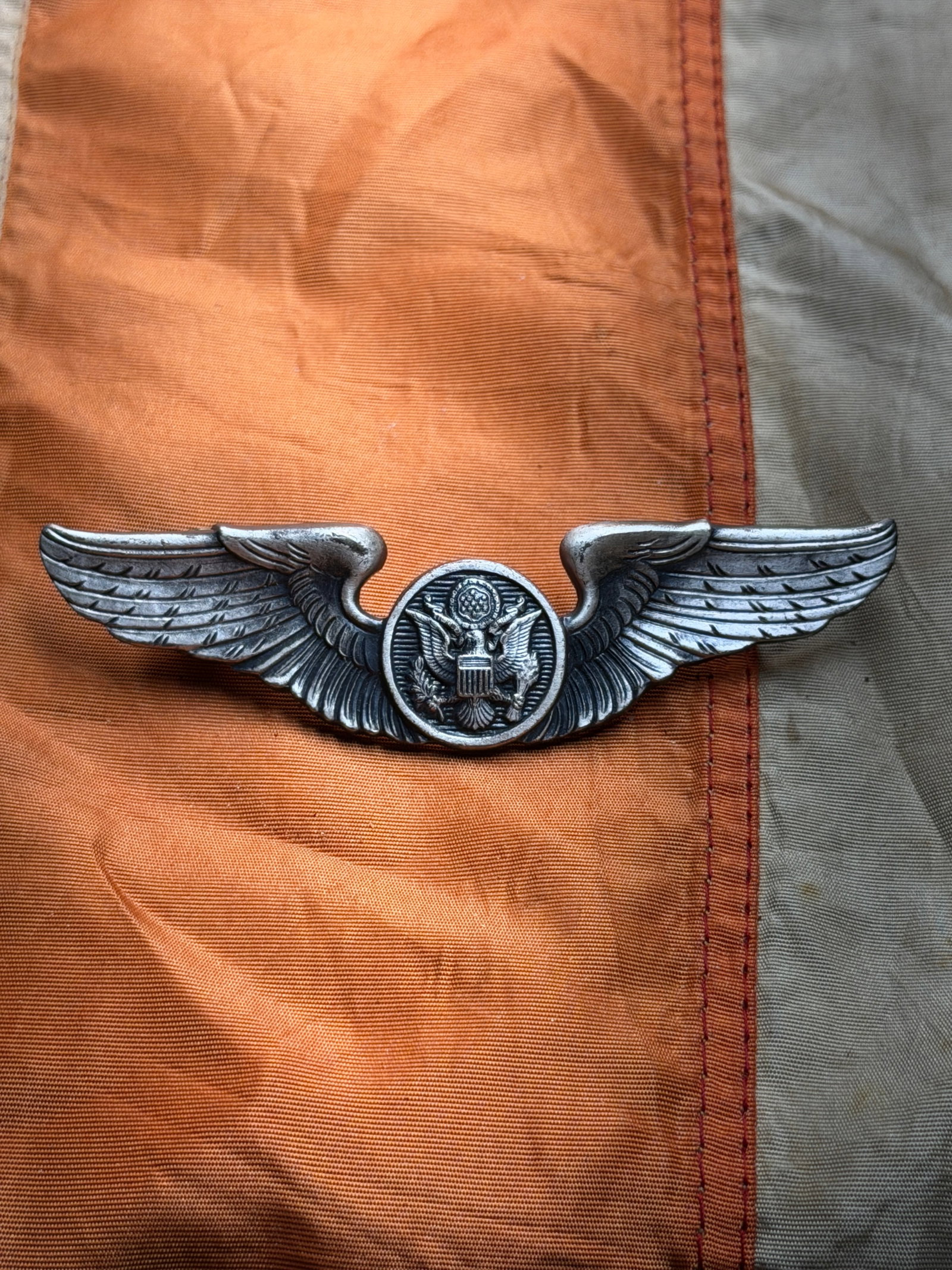 Civil War Confederate States Field Spyglass: This metal aviation wings insignia represents qualification as an aircrew member of the United States Army Air Forces (USAAF), the aerial warfare branch of the U.S. Army during World War II. The horiz