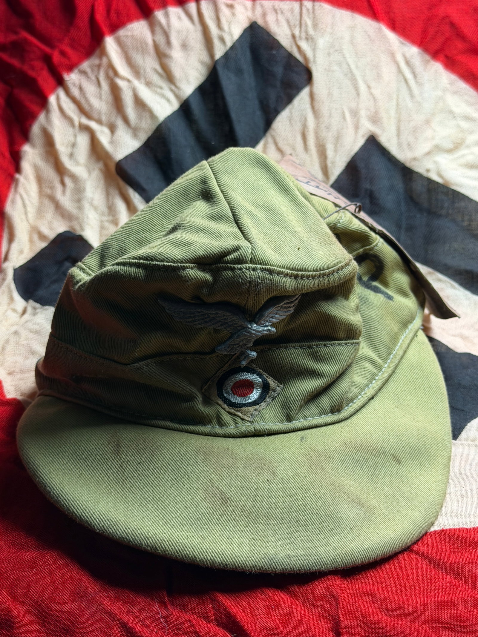 WW2 Field Cap of the German Afrika Korps (M40 Tropical Cap): This olive-drab cotton field cap is a German World War II tropical service cap, commonly referred to as the M40 Afrikakorps cap. Designed for use in hot climates, it was issued to German forces deploy