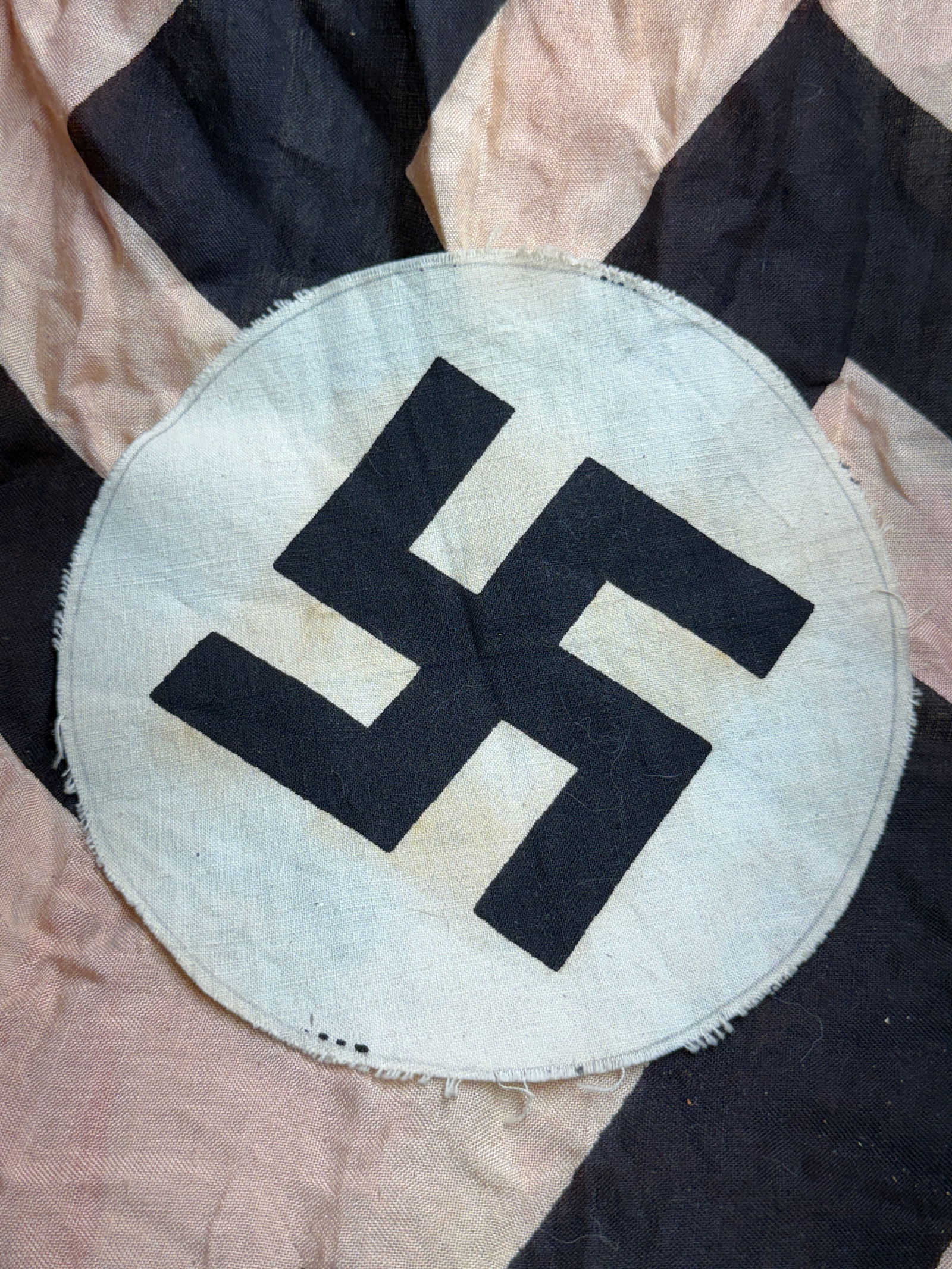 WW2 German National Socialist Party Armband Insignia (Sleeve Emblem): This textile artifact is a National Socialist Party (NSDAP) armband insignia, produced in Germany during the Third Reich (c. 1933–1945). It consists of a black swastika appliquéd onto a white circu