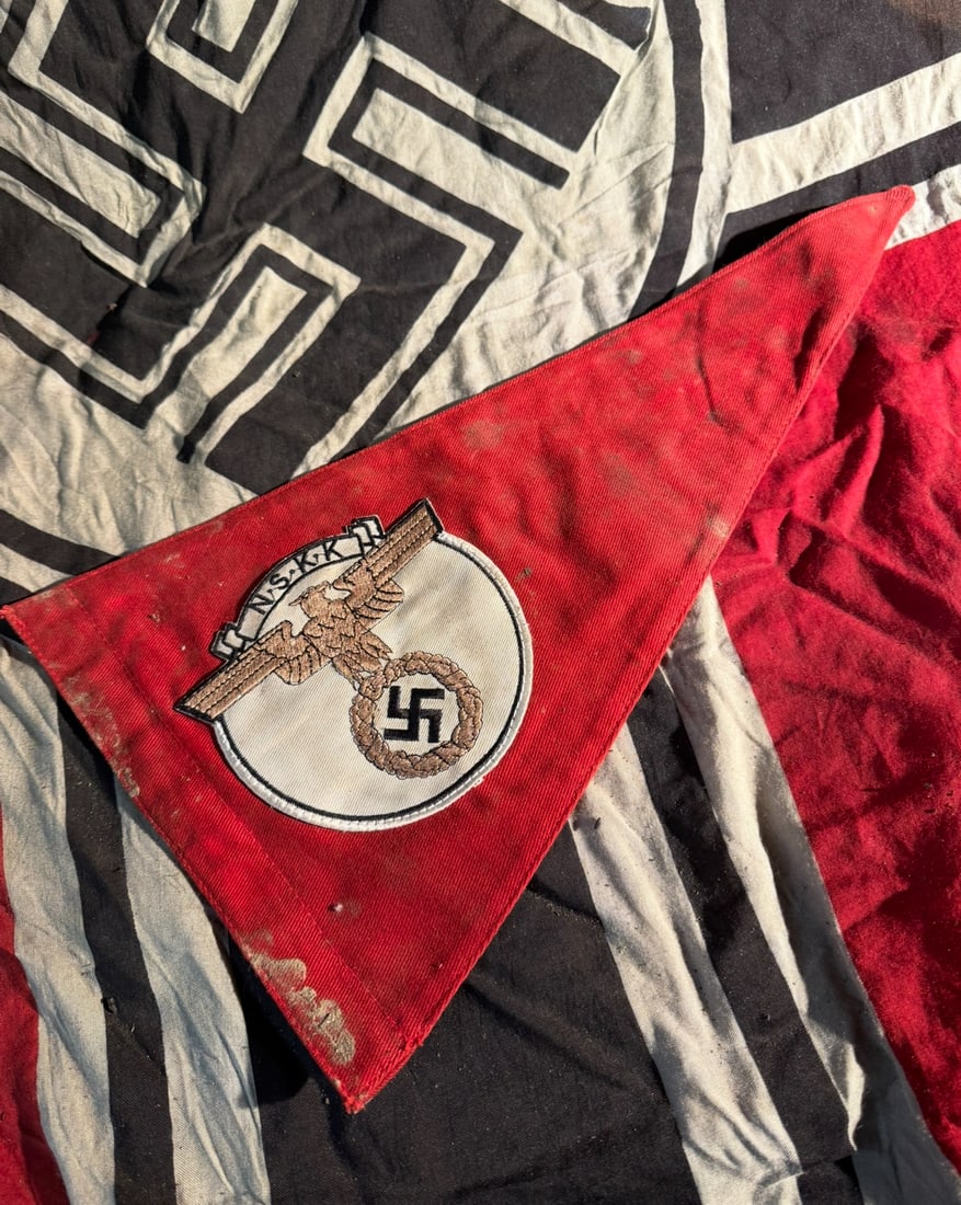 WW2 German National Socialist Motor Corps (NSKK) Pennant / Vehicle or Unit Flag: This triangular red pennant bears the embroidered insignia of the Nationalsozialistisches Kraftfahrkorps (NSKK), a paramilitary organization of Nazi Germany active from 1931 to 1945. The central emble