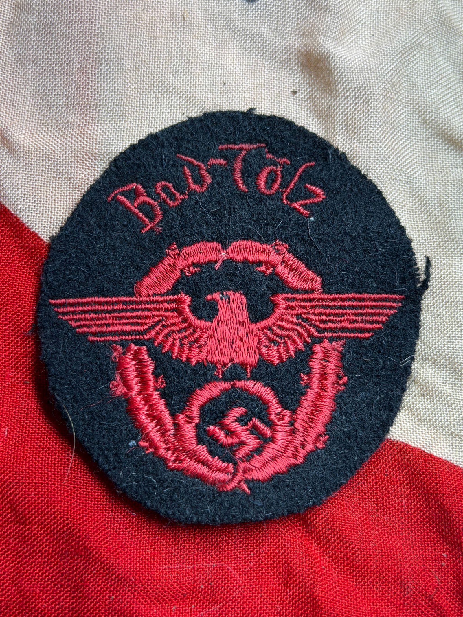 WW2 German Feuerschutzpolizei Sleeve Eagle Patch, Bad Tölz: This embroidered cloth sleeve insignia is identified as a World War II–era German Feuerschutzpolizei (Fire Protection Police) non-commissioned officer’s patch associated with the town of Bad Tölz