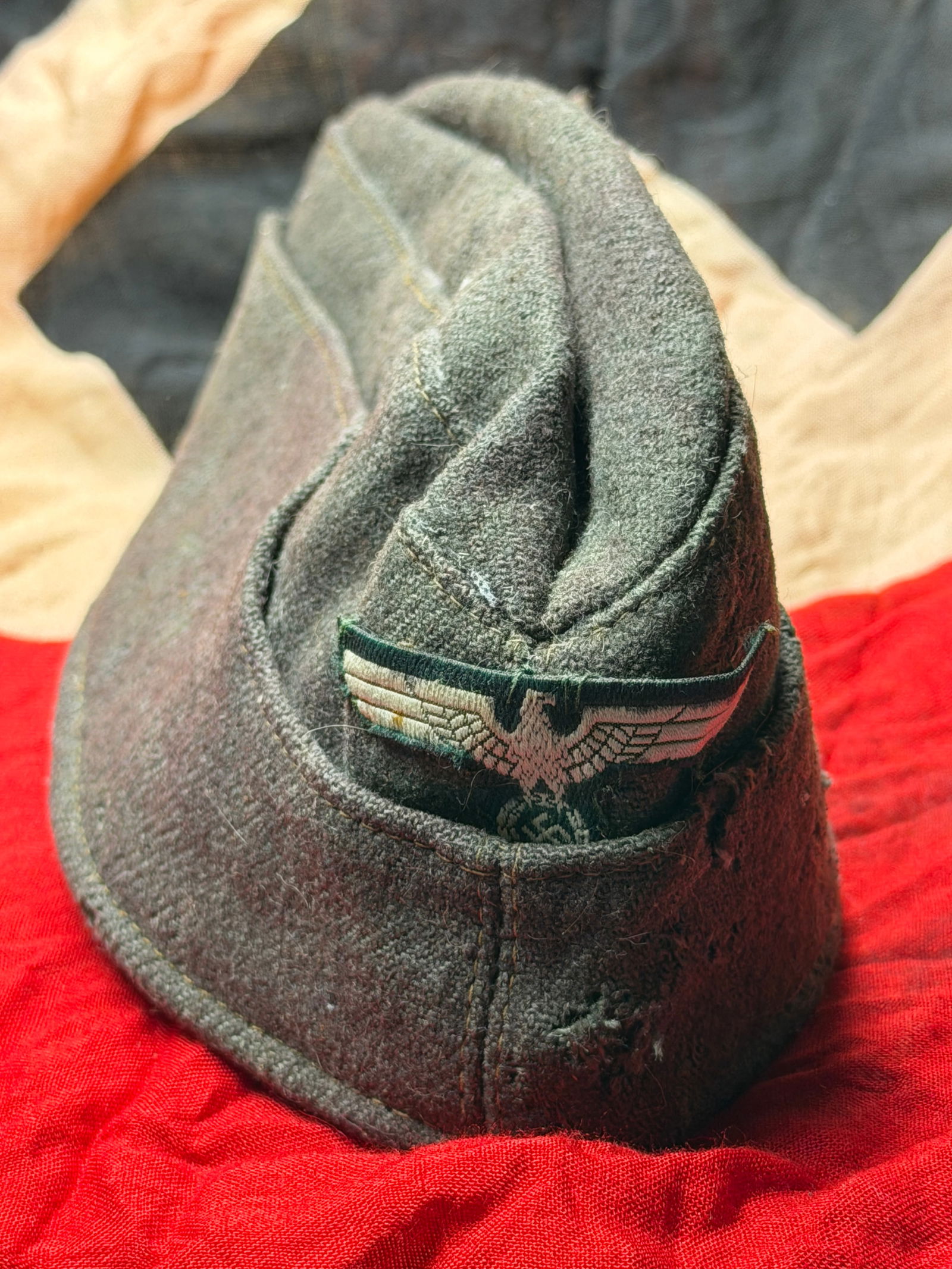 WW2 German Army Side Cap (Feldmütze / Schiffchen), Wehrmacht, c. 1939–1945 - Maker Marked: This woolen field cap, commonly known as a Schiffchen or side cap, was worn by enlisted personnel of the German Army (Heer) during the Second World War. Has a maker mark stamp on the inside. Construct