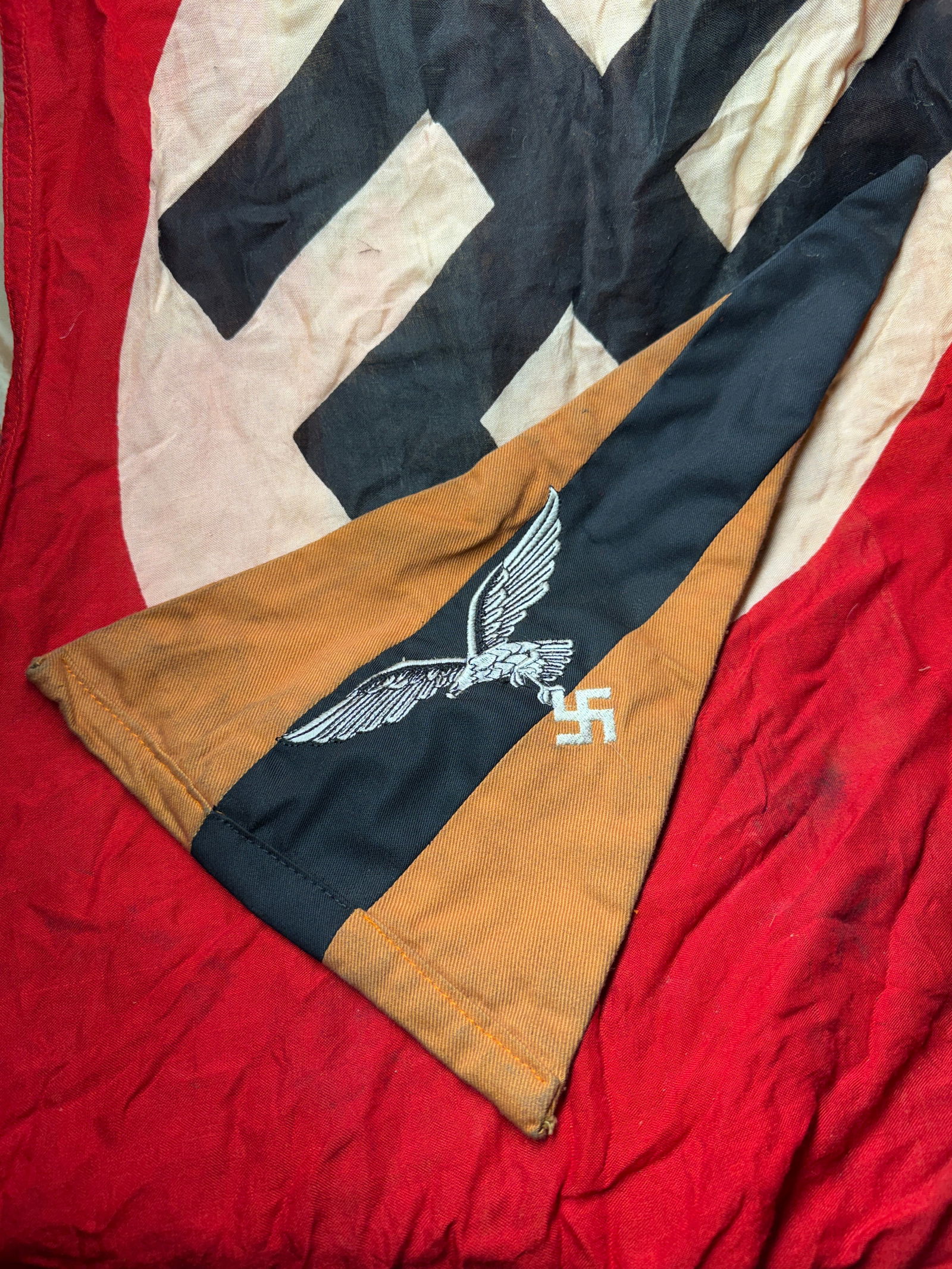 WW2 German Luftwaffe Vehicle Pennant (Fahrzeugwimpel), Nazi Germany, c. 1935–1945: This triangular cloth pennant was used by the German Luftwaffe as a vehicle or positional identifier during the Second World War. Constructed from cotton or wool fabric in black and golden-brown field