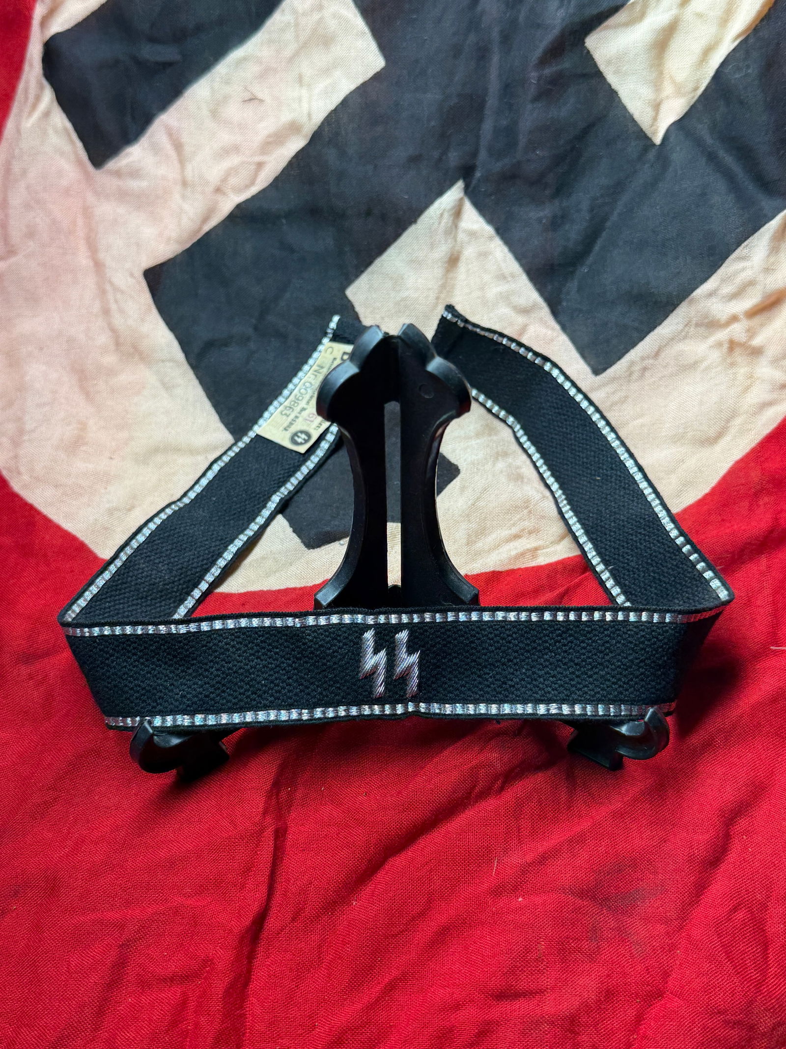 WW2 German SS Cuff Title (Ärmelstreifen) with RZM Paper Tag, Schutzstaffel (SS), Nazi Germany, c.: This woven cloth cuff title (Ärmelstreifen) was worn on the lower sleeve of SS uniforms during the Second World War. Executed in black fabric with silver-gray woven borders, the cuff title features t