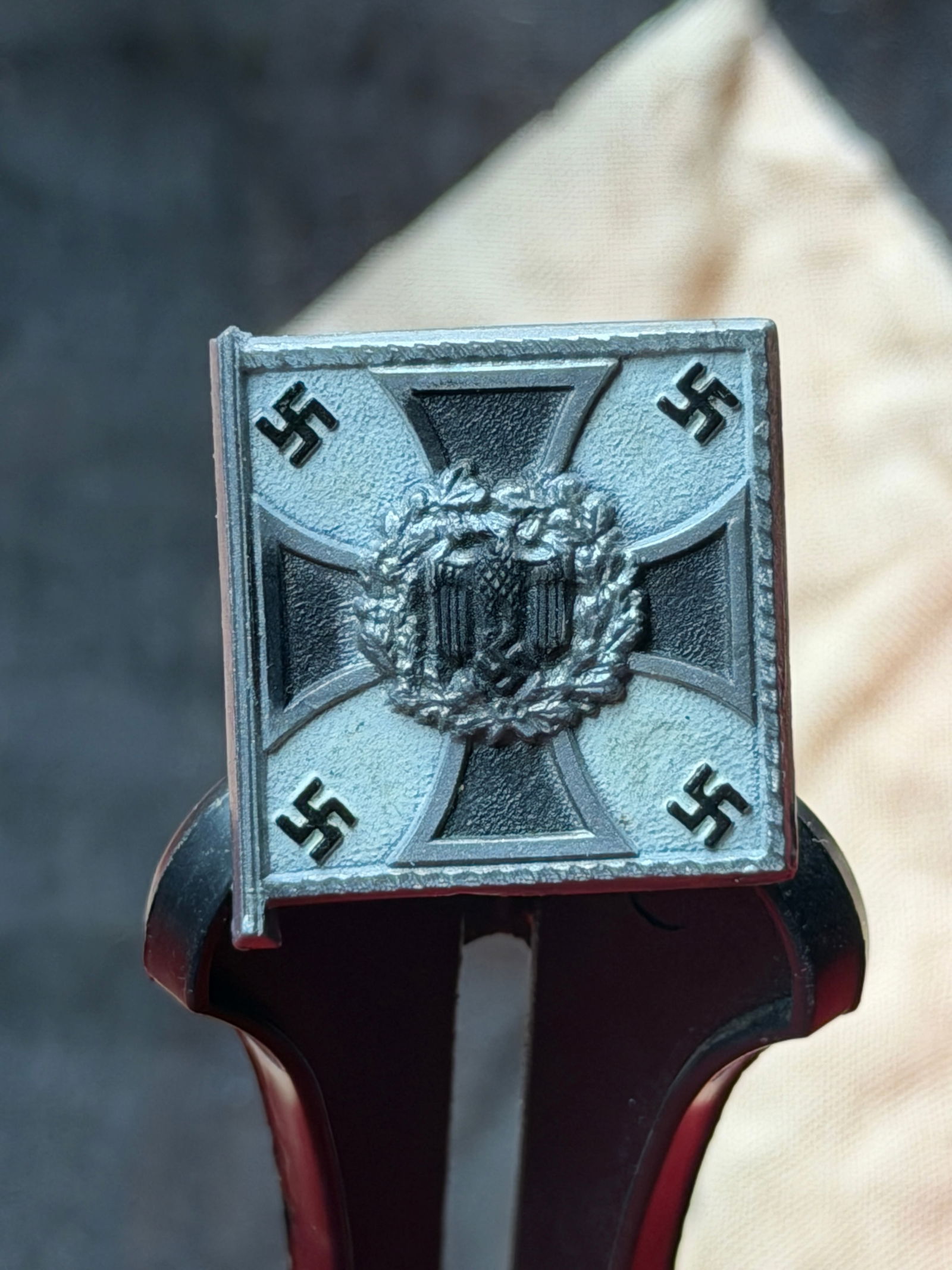 WW2 German Infantry Flag Membership Badge (Infanterie-Fahne), Nazi Germany, c. 1935–1945: This small metal badge, cast in the form of a stylized flag, represents infantry affiliation within Nazi Germany’s paramilitary and veterans’ culture during the Third Reich. The obverse design cen