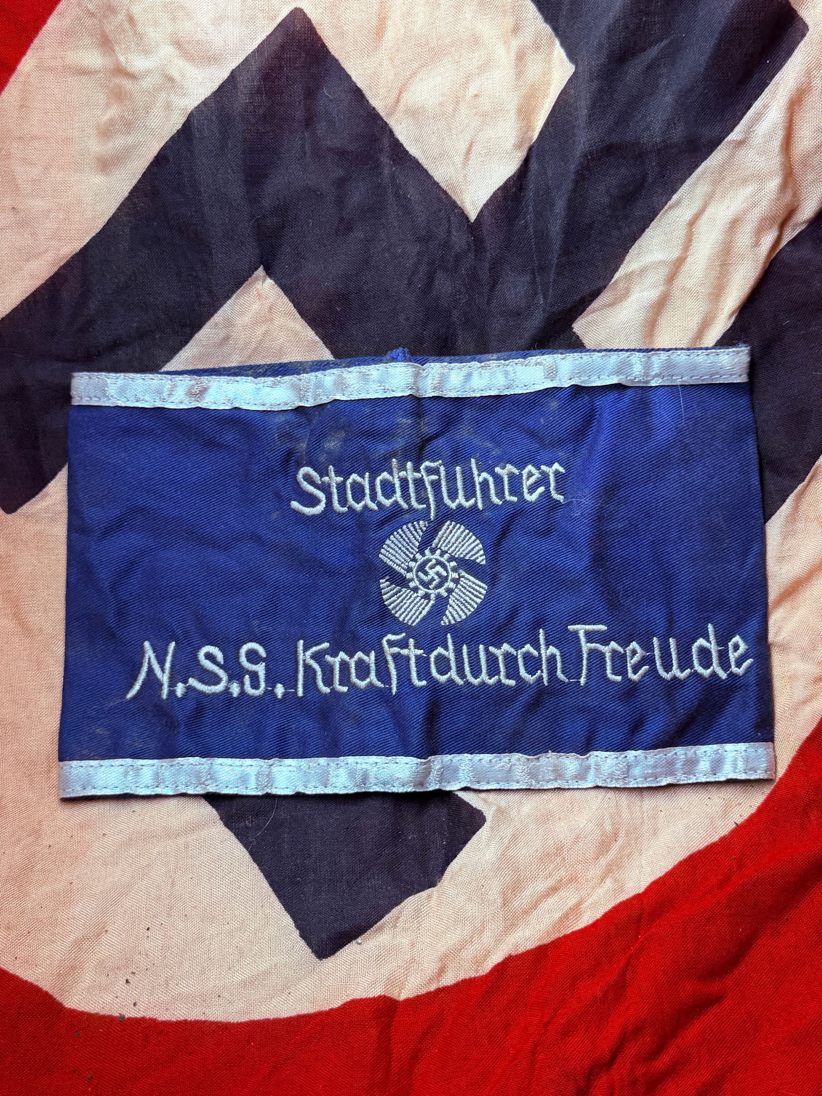 WW2 German NS “Kraft durch Freude?? City Leader Armband (Stadtführer) With RZM Paper Tag: This blue cloth armband was worn by a Stadtführer (City Leader) of the Nationalsozialistische Gemeinschaft “Kraft durch Freude” (NSG KdF), translated as “Strength Through Joy.” KdF wa