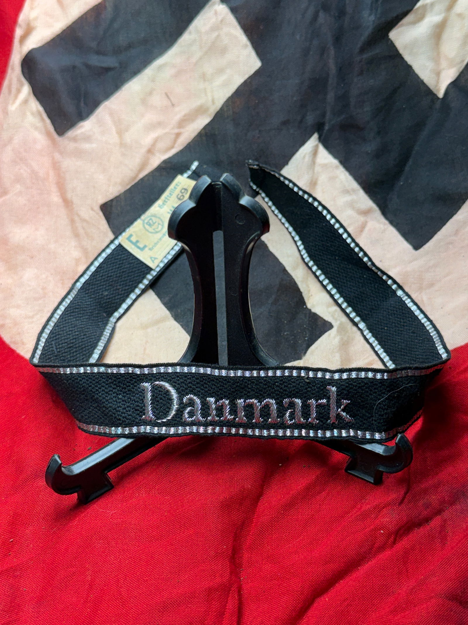 WW2 German SS Volunteer Cuff Title “Danmark?? with RZM Tag: This cuff title bears the inscription “Danmark” and was worn by Danish volunteers serving in Waffen-SS formations during the Second World War. Executed in black woven fabric with silver-gray G