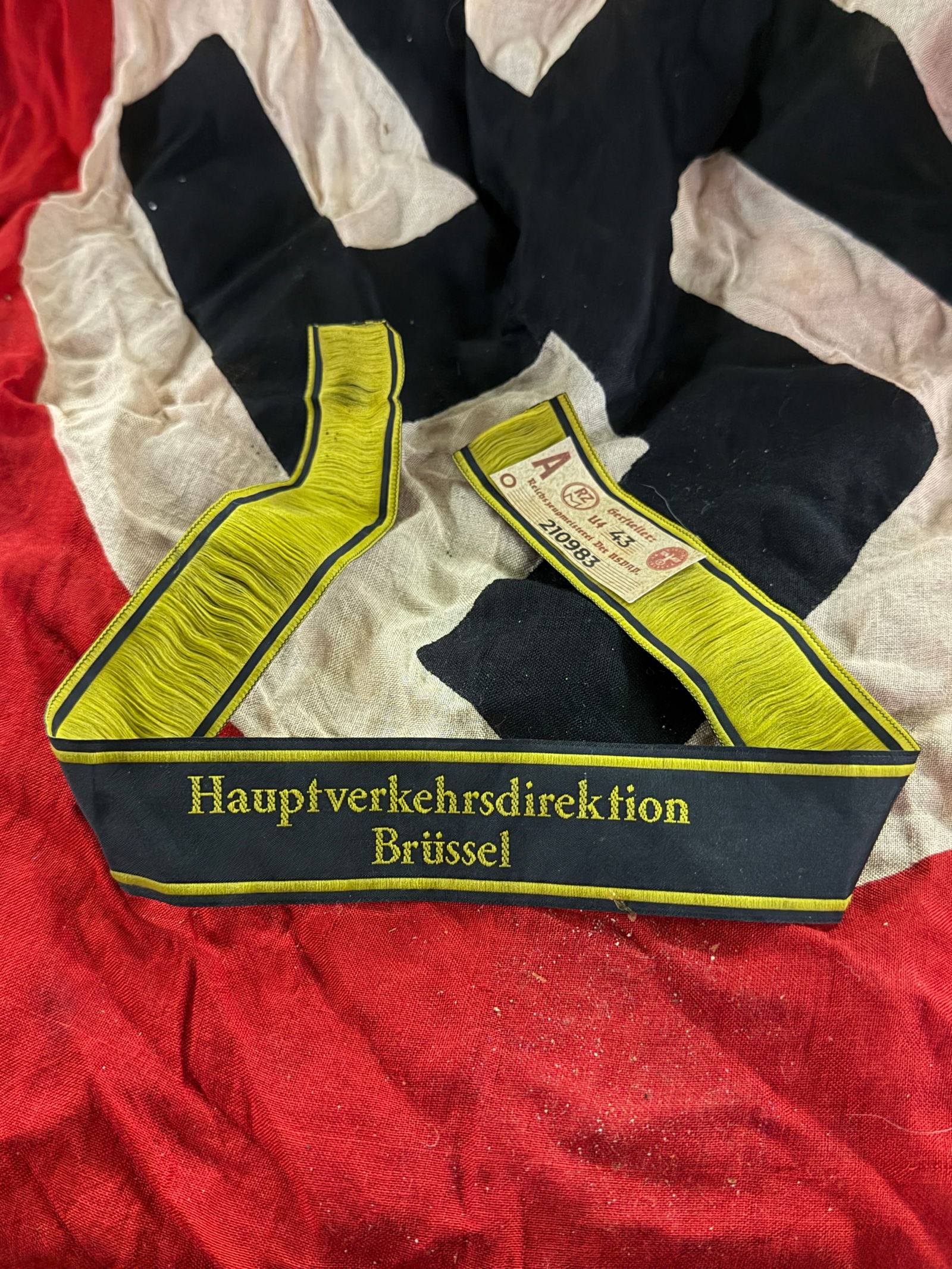 WW2 German Occupation Railway Official’s Armband – Brussels World War II Era, German-Occupied: This cloth armband dates to the World War II German occupation of Belgium and is identified by the embroidered inscription “Hauptverkehrsdirektion Brüssel” (“Main Transport Directorate, Bru