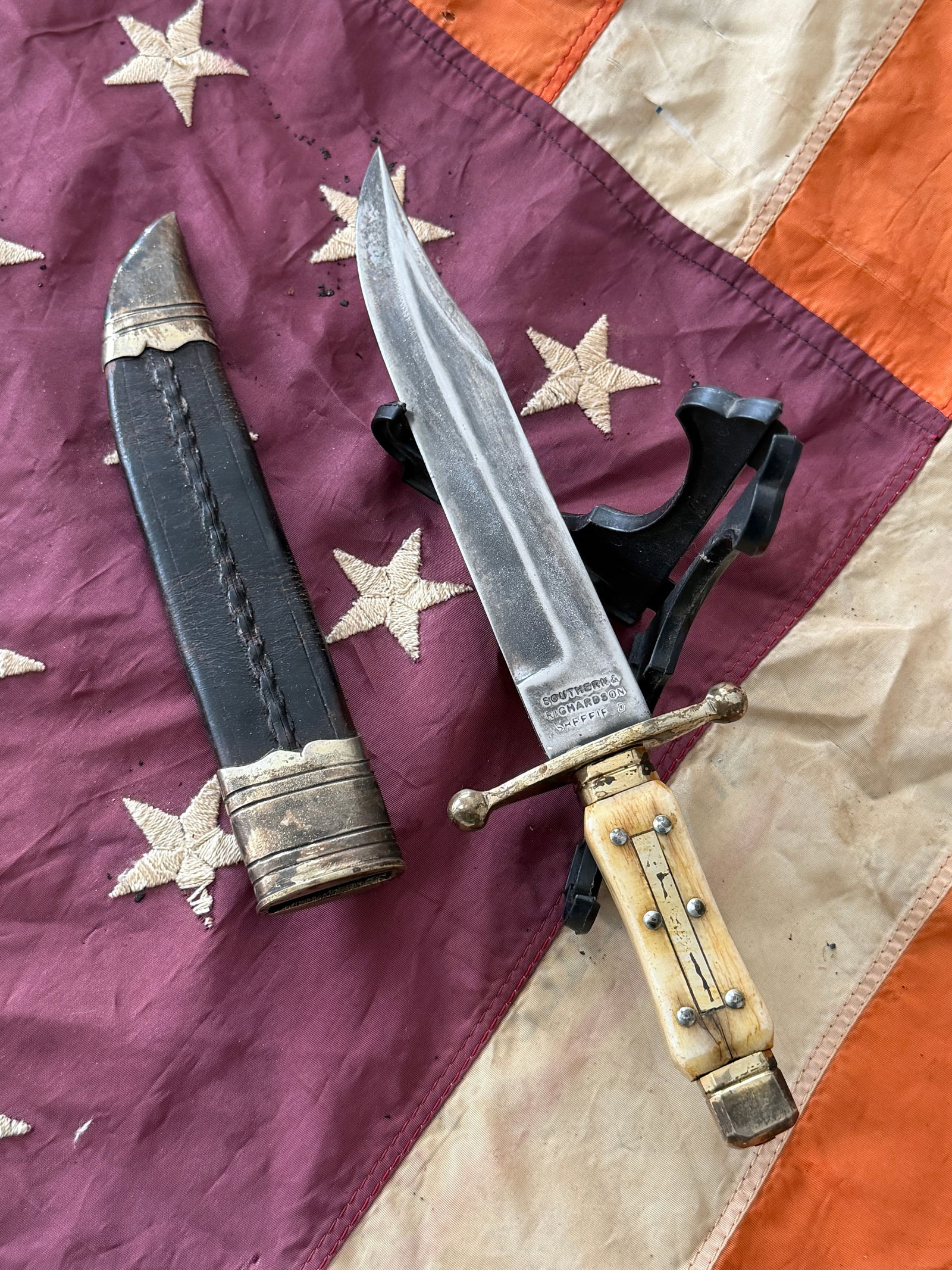 1800s British Bowie-Style Fighting Knife with Scabbard By Southern & Richardson, Sheffield, England: This large Bowie-style fighting knife was manufactured by Southern & Richardson of Sheffield, one of England’s prominent cutlery firms during the mid-19th century. The maker’s stamp on the blade r