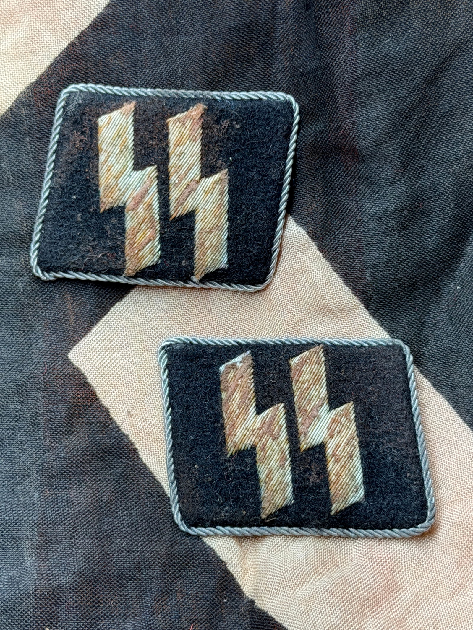 WW2 German Waffen-SS Collar Tabs (Pair), Germany, c. 1939–1945 With RZM Paper Tag: These paired black wool collar tabs bear the embroidered Sig runes, the insignia of the Waffen-SS, the armed branch of the SS during the Second World War. Worn on the collar of the uniform tunic, the