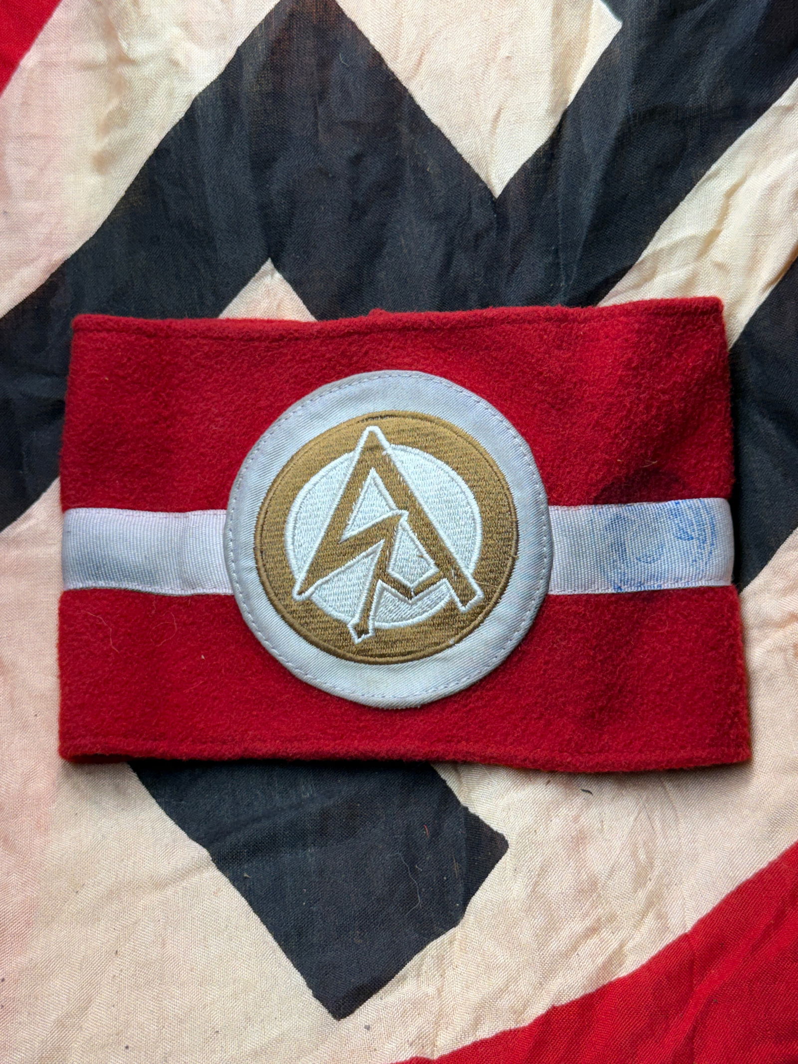 WW2 German SA Armband with RZM Certification Tag: German armband dates to the National Socialist period and is associated with the Sturmabteilung (SA), the Nazi Party’s early paramilitary organization. Constructed from red wool felt, the armband fe