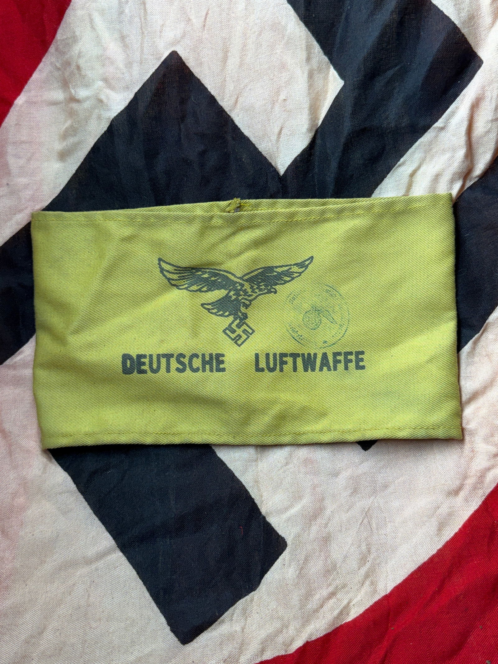 WW2 Armband of the German Luftwaffe, Third Reich With RZM Paper Tag: This armband bears the printed eagle-and-swastika emblem of the Deutsche Luftwaffe, the air force of Nazi Germany, and was worn as an identification or duty armband during the Second World War. Constr