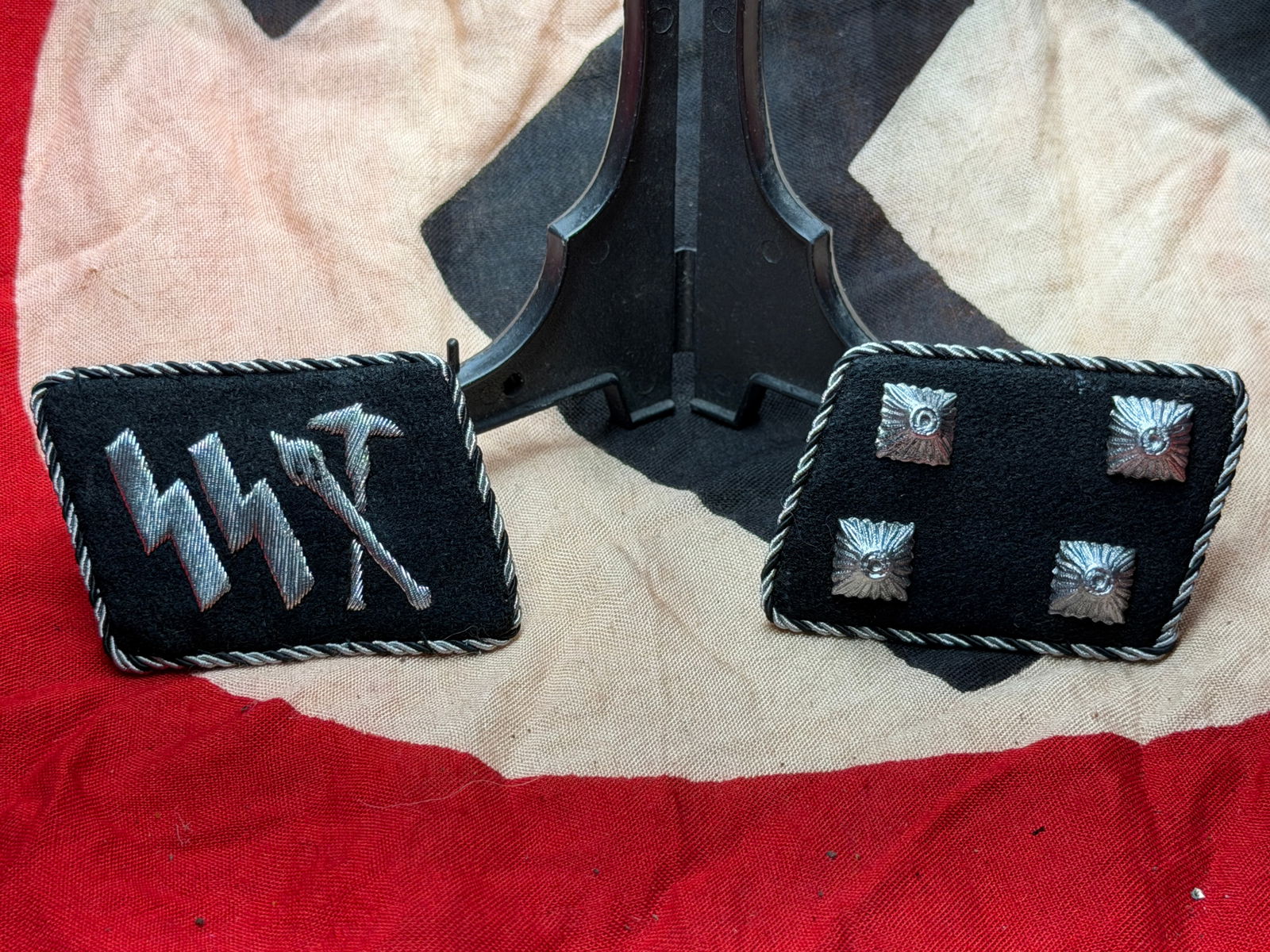 WW2 German SS Officer Collar Tabs (Kragenspiegel), Third Reich, c. 1939–1945: This matched pair of black wool collar tabs (Kragenspiegel) belonged to an officer of the Schutzstaffel (SS), an elite organization of Nazi Germany. The left tab bears the embroidered SS runes, identi