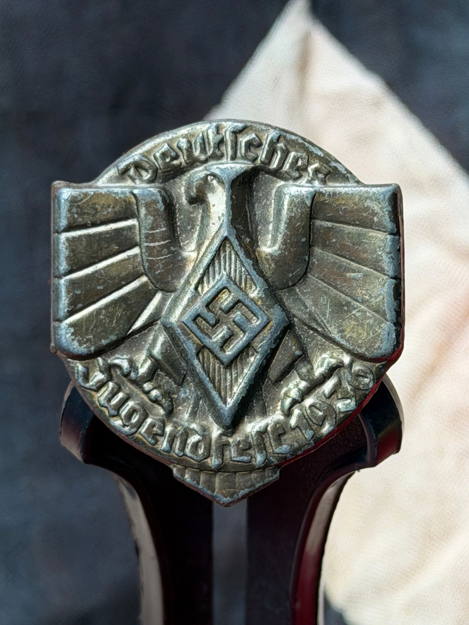 WW2 German Hitler Youth Membership Badge (HJ-Abzeichen): This metal badge is an original membership emblem of the Hitler Youth (Hitlerjugend), the official youth organization of the National Socialist regime in Germany. Issued to enrolled members, the badge