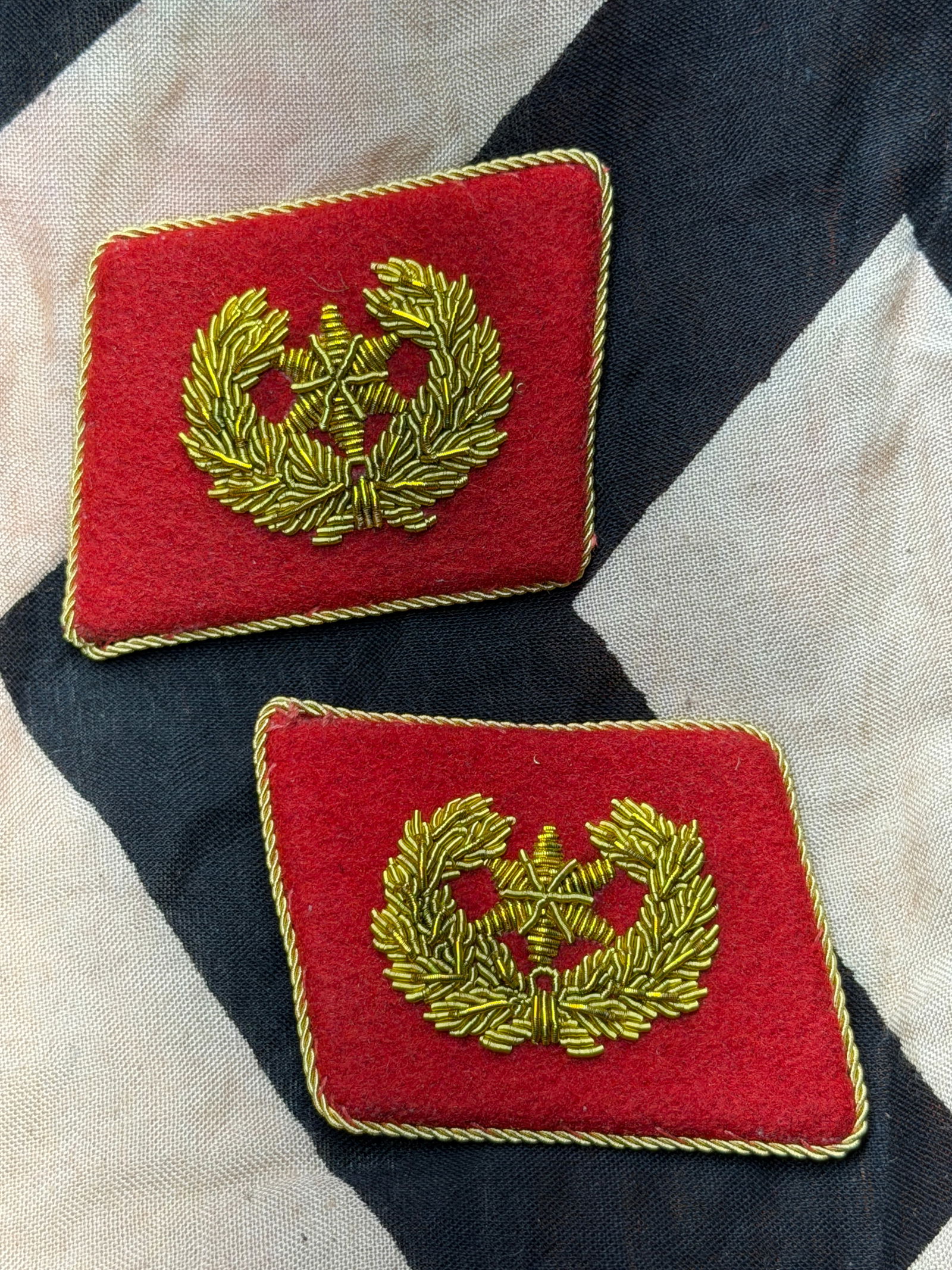 Rare WW2 German SS Officer Collar Tabs with RZM Control Tag (Pair): This matched pair of Waffen-SS officer collar tabs dates to the period of the Third Reich (1933–1945). Constructed of red wool backing with gold bullion embroidery, each tab features an oak-leaf wre