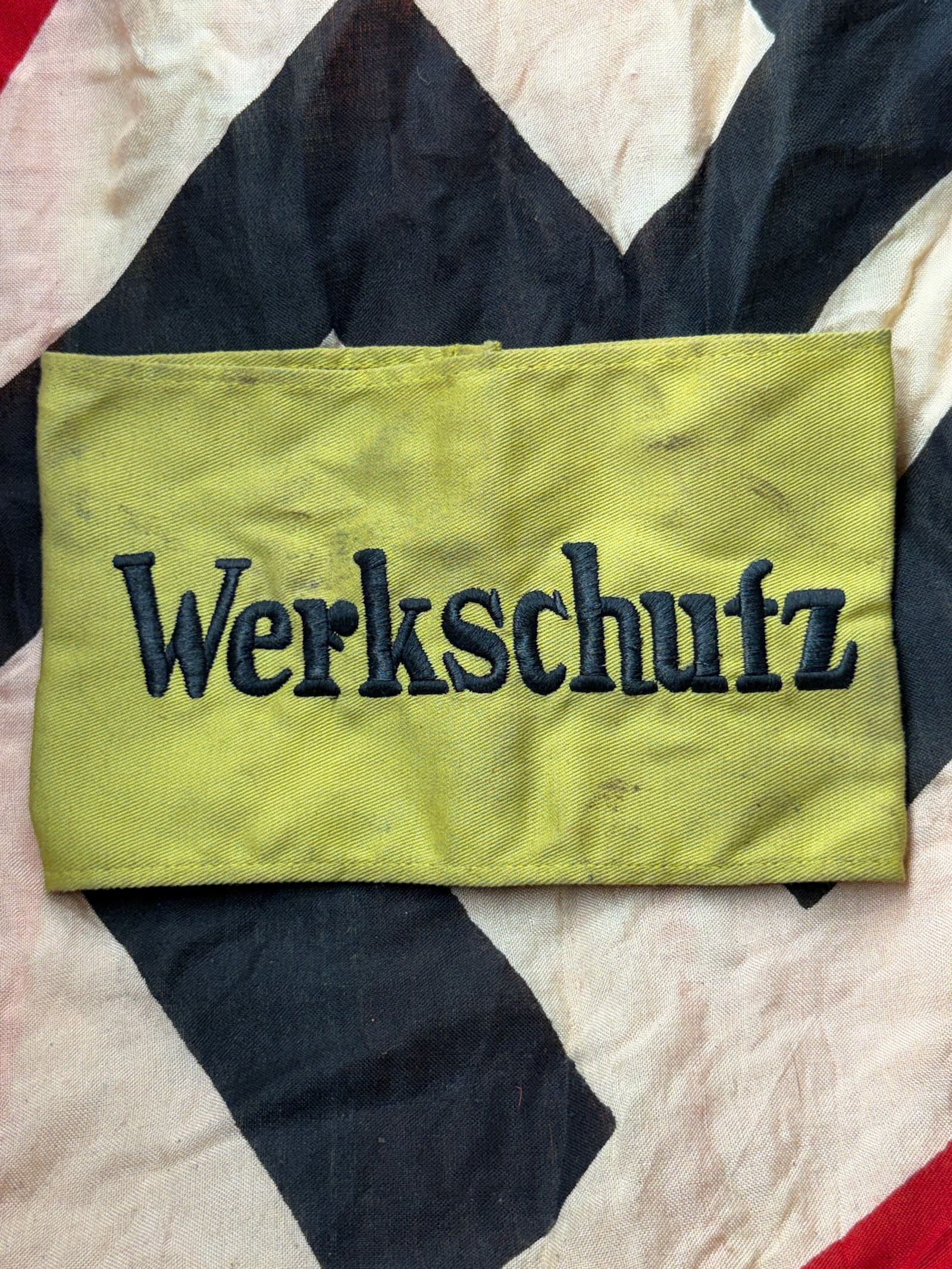 WW2 German Cuff Title “Werkschutz?? (Factory Security), Third Reich Germany: This embroidered cuff title bears the inscription “Werkschutz” (“Factory Security”) and was worn on the lower sleeve of uniforms by members of industrial plant and facility security un