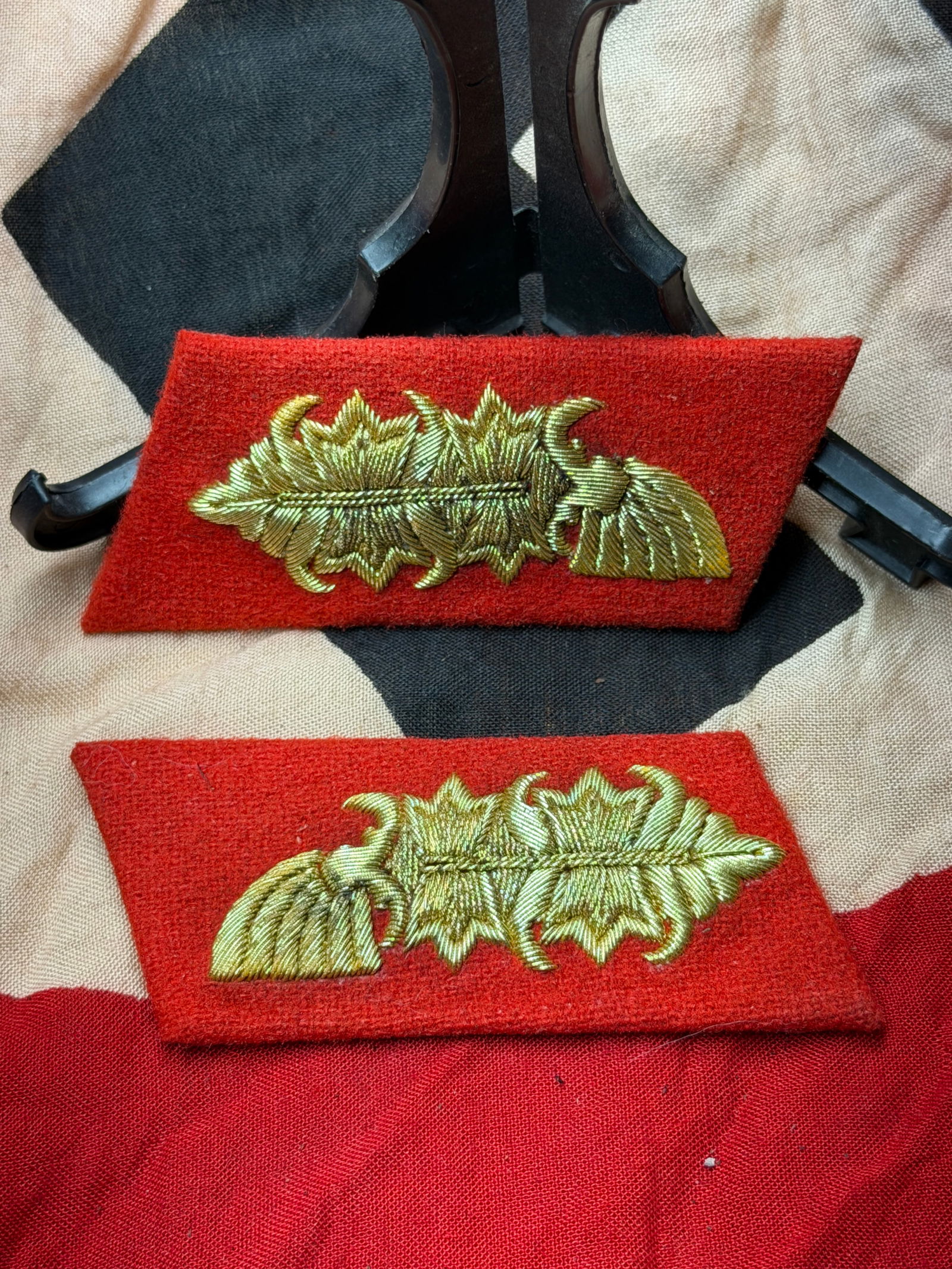 Pair of Waffen-SS Senior Officer Collar Tabs with Oak Leaf Insignia: This matched pair of red wool collar tabs bears embroidered oak leaf insignia executed in metallic bullion thread, denoting senior officer rank within the Waffen-SS during the Second World War. The oa