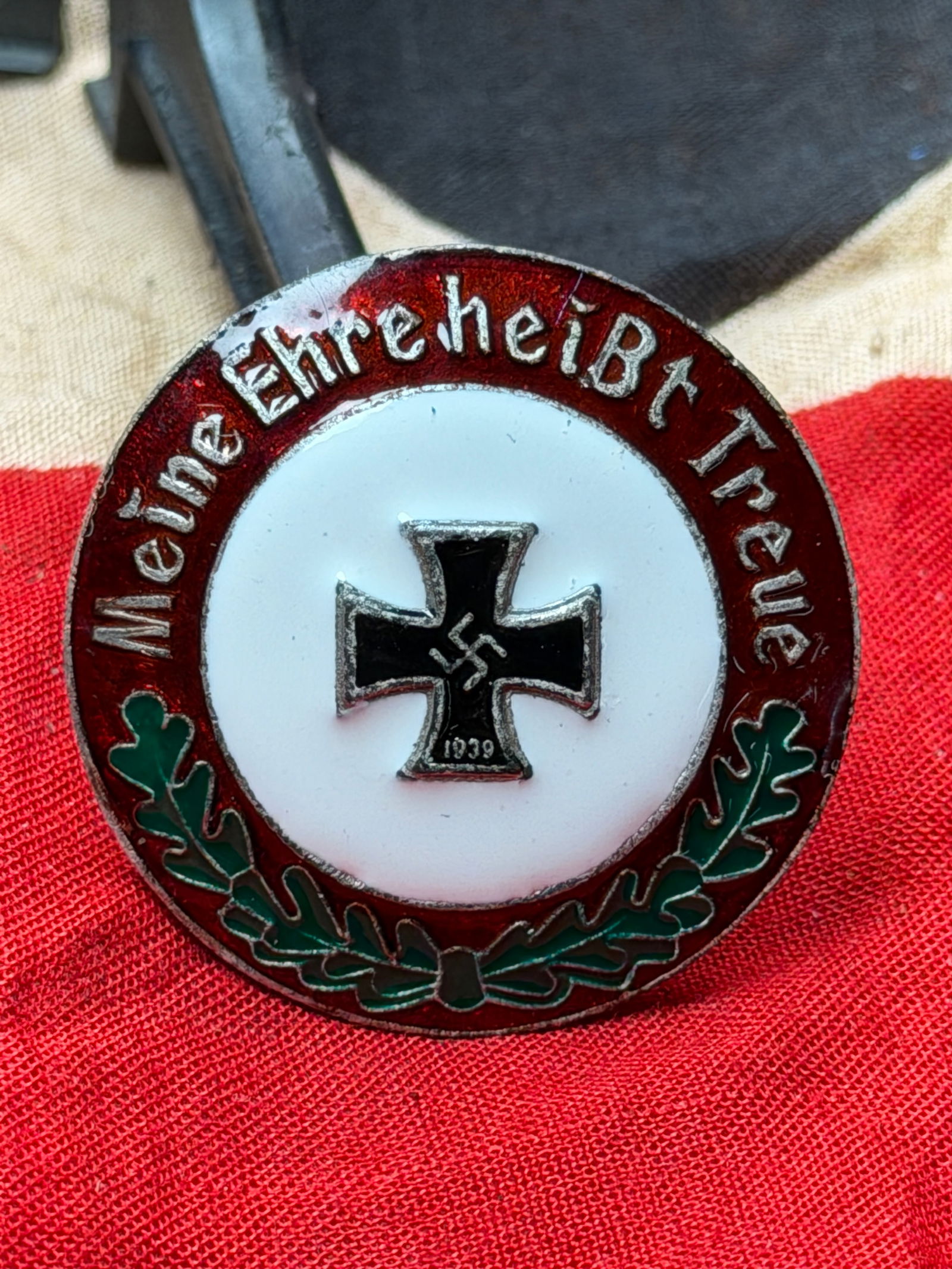 WW2 German Waffen SS Anti-Partisan Commemorative Enamel Badge (Partisanenabzeichen), c. 1943–1944: This enamelled badge is associated with SS anti-partisan operations conducted during the Second World War, particularly in occupied Eastern Europe and the Balkans. The circular design features a centr