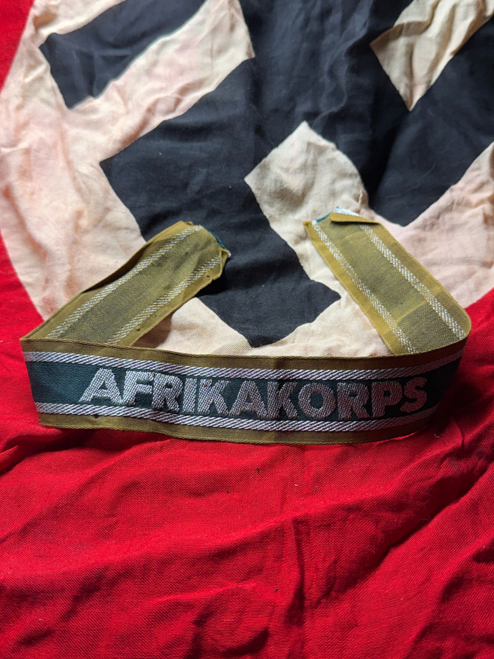 WW2 German "Afrika Korps" Cuff Title – Tropical Uniform Sleeve Band: World War II–era German “Afrika Korps” cuff title, associated with units serving in the North African campaign. This style of sleeve band was worn on the lower sleeve of uniforms by personne