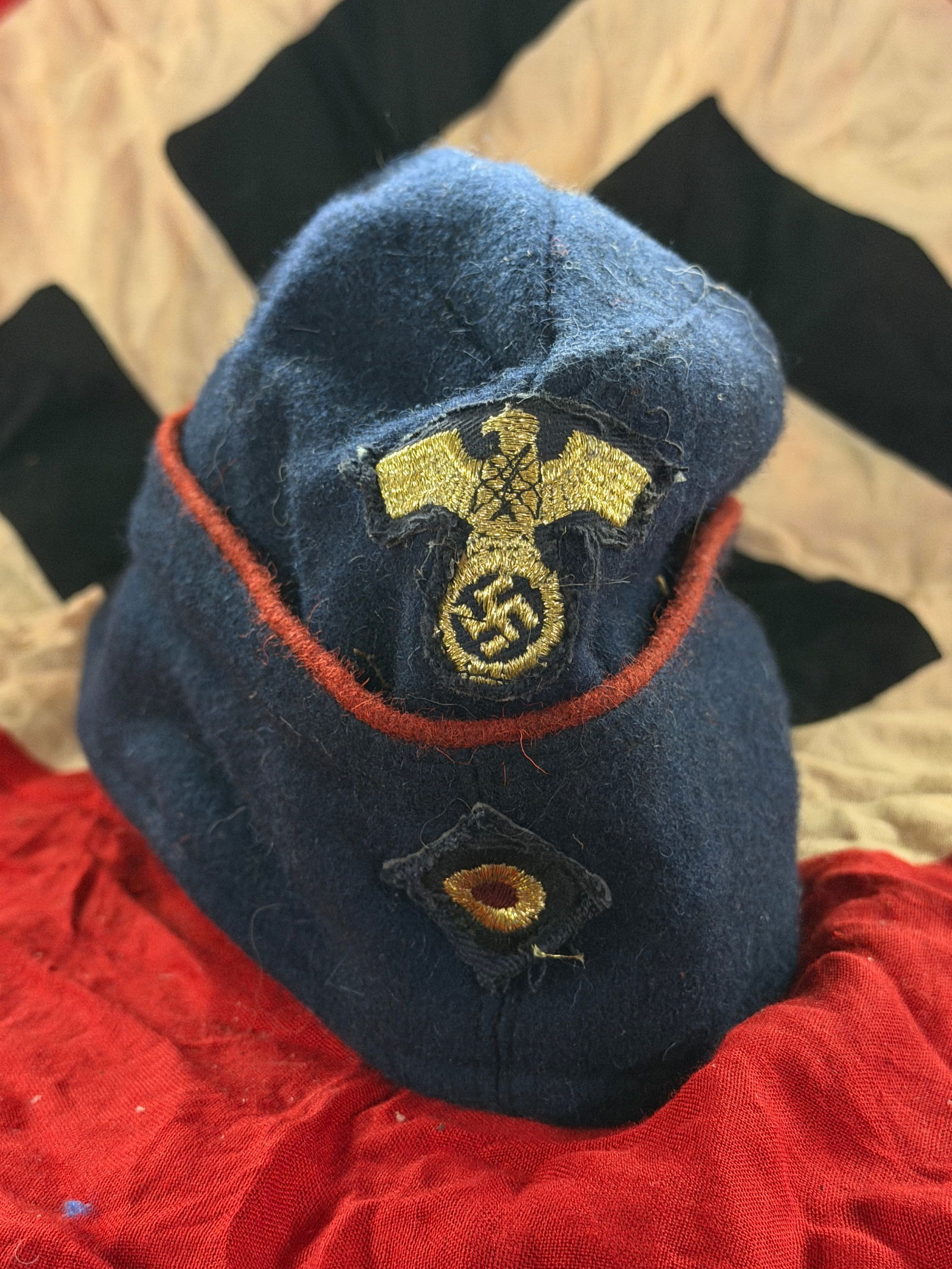 WW2 German Police/Paramilitary Cap with Eagle Insignia: This blue wool cap dates to World War II–era Germany and bears an embroidered German eagle insignia, a symbol used across multiple state and paramilitary organizations during the Nazi period (1933��