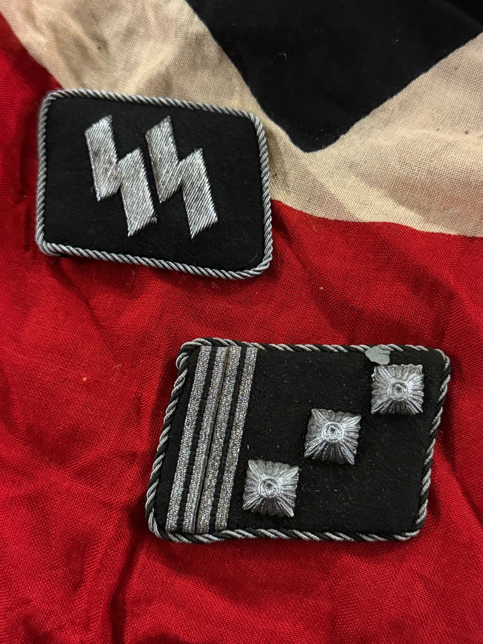 Pair Of WW2 German Waffen SS Collar Tabs With RZM Paper Tag: Pair Of WW2 German Waffen SS Collar Tabs With RZM Paper Tag. This paired set of SS collar patches dates to the period of Nazi Germany (1933–1945) and illustrates how rank and organizational identity