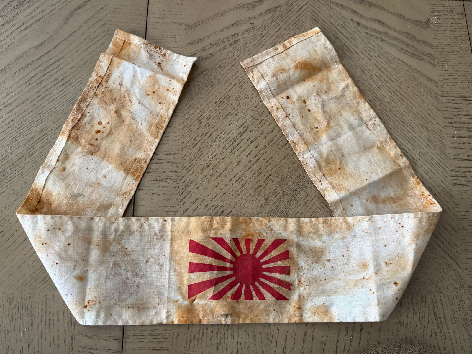 WWII Imperial Japanese Kamikaze Pilot Rising Sun Hachimaki Headband: World War II Imperial Japanese hachimaki headband associated with Kamikaze (Special Attack) pilots. Made from lightweight cotton, this headband features the bold red Rising Sun emblem, a powerful symb