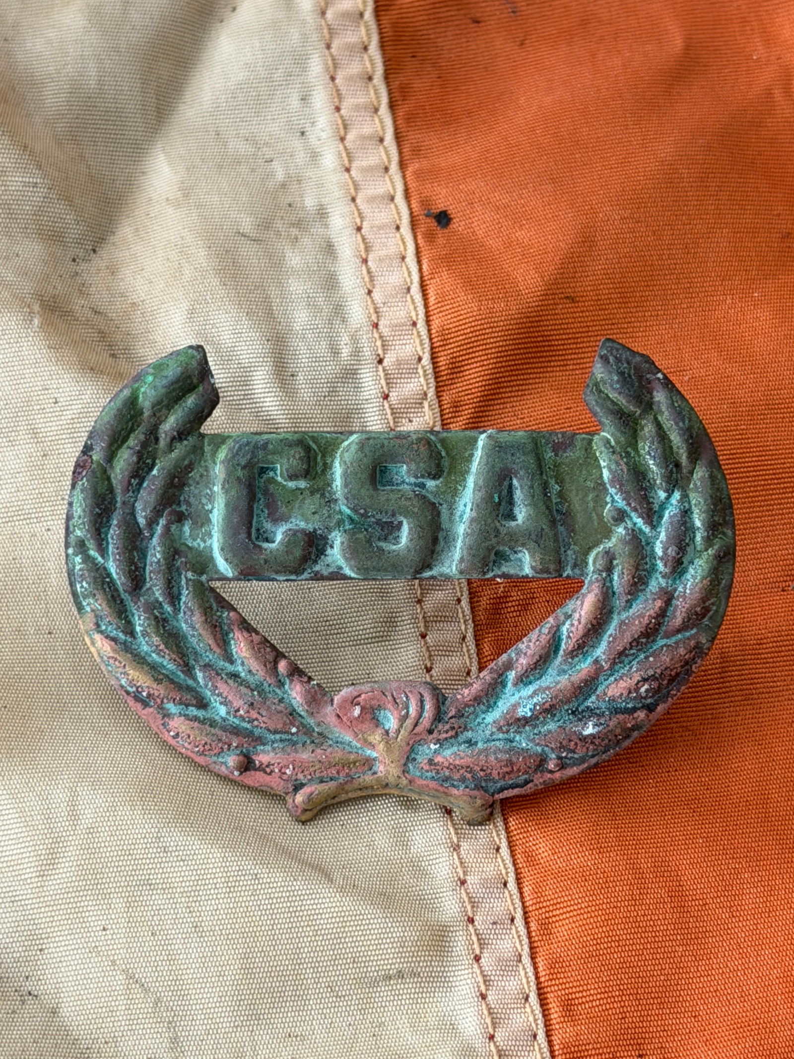 Civil War Confederate States Army “CSA?? Wreath Headgear Badge: This cast brass headgear badge, emblazoned with the letters “CSA” encircled by a laurel wreath, dates to the American Civil War (1861–1865) and was worn by soldiers of the Confederate States