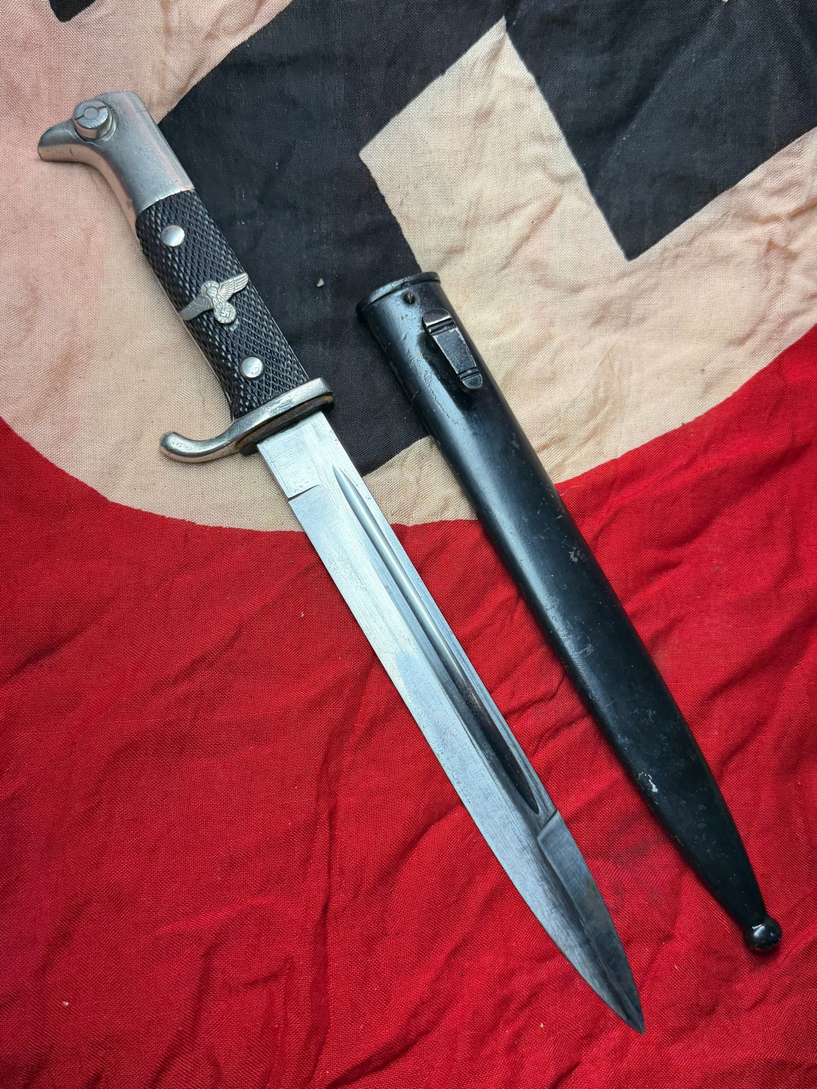 WW2 German Police/SS Bayonet with Scabbard, Third Reich Era: This edged weapon is a German bayonet dating to the period of National Socialist rule in Germany (1933–1945). Characterized by its single-edged steel blade with a central fuller, black checkered gri