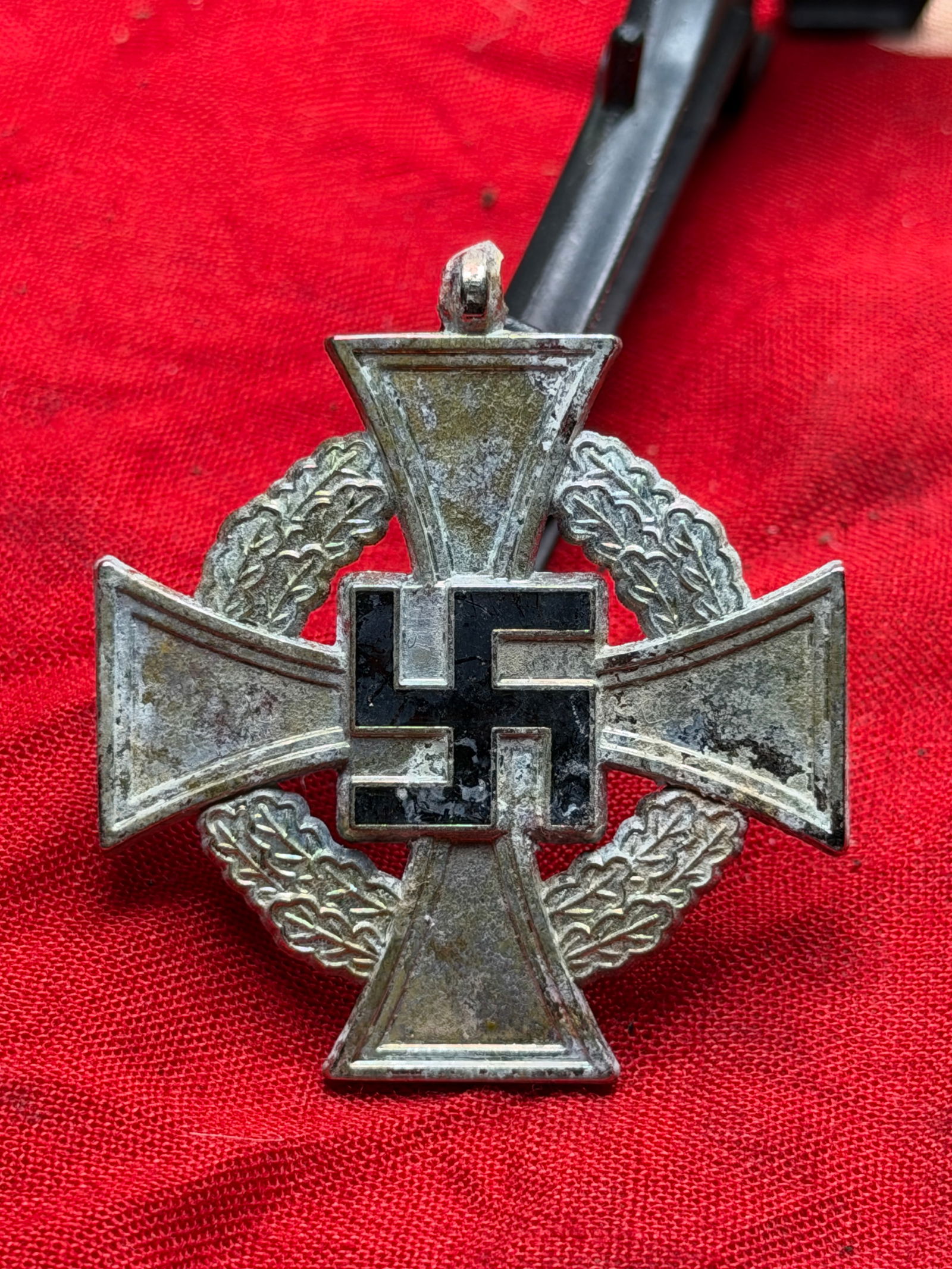 WW2 German Faithful Service Cross with Oakleaf Wreath (Treue Dienste), Third Reich Germany: This metal decoration represents a German “Treue Dienste” (Faithful Service) cross from the period of National Socialist rule in Germany (1933–1945). The cross form, encircled by an oakleaf
